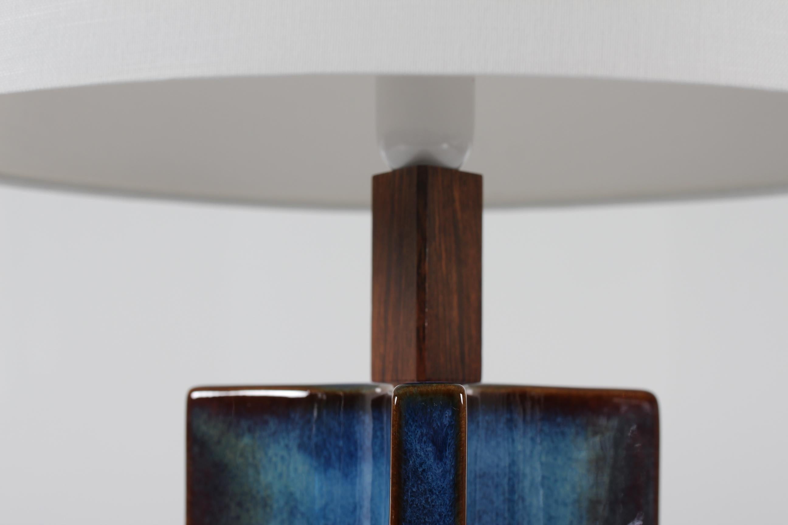 Tall and are sculptural table lamp from Søholm Stentøj, Denmark, circa 1960s.
The lamp has glaze with a beautiful color play in almost blue notes.

Included is a new lamp shade designed and made in Denmark. It's made of woven fabric with some