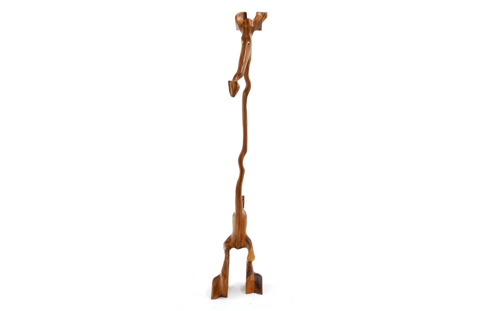 Whimsical large animal sculpture (dog? kangaroo? giraffe? or trippy made up animal? whatever it is, it's cool!) signed by artist Knud Albert, Denmark, 1960s. Solid meticulously carved teak in a cartoonish form with plastic eyes. We have taken