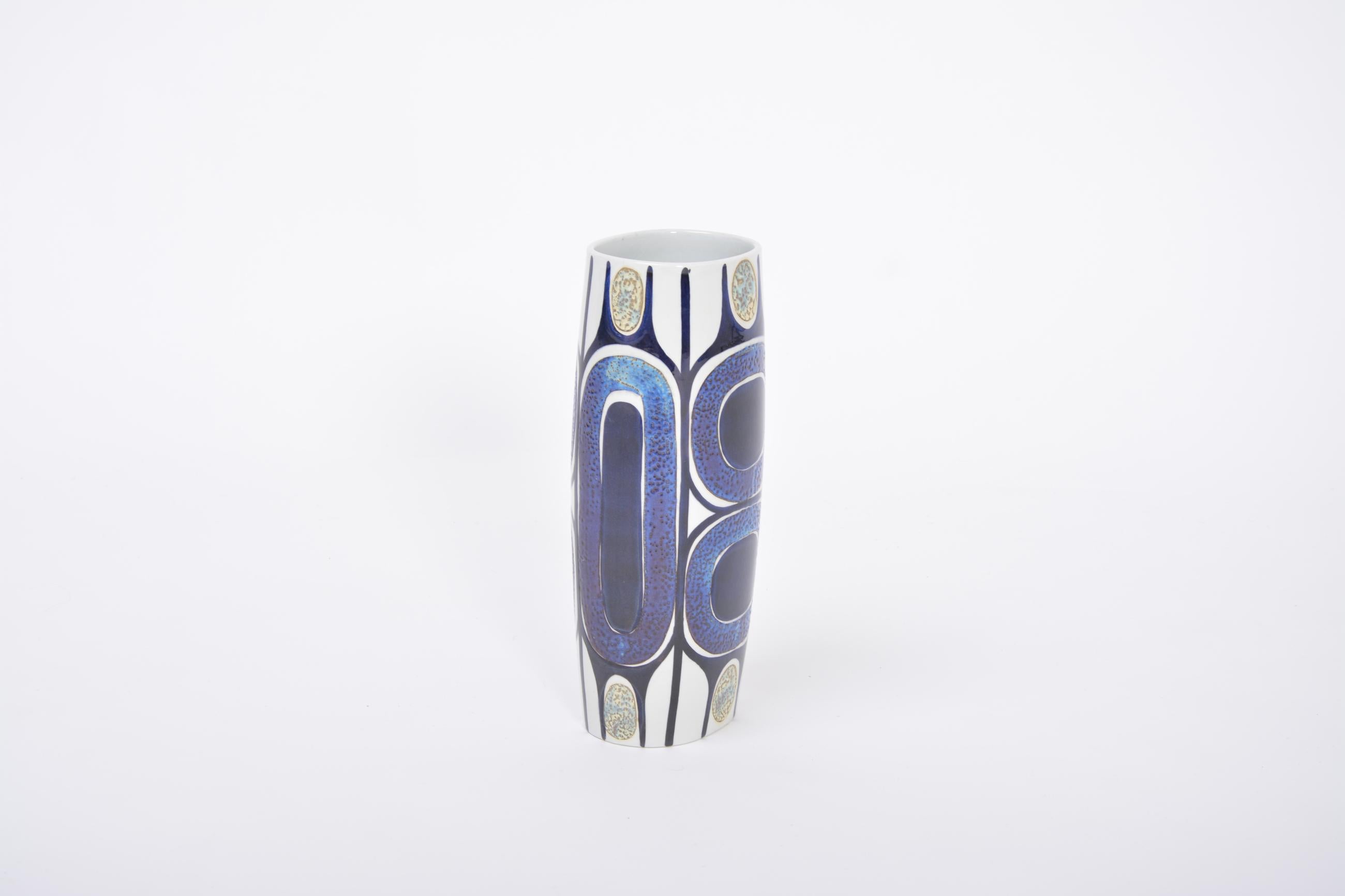 Tall Danish Tenera mid-century vase by Inge-Lise Koefoed for Royal Copenhagen 
Tall and eye-catching vase from the Royal Copenhagen Tenera series with gorgeous hand painted decor designed by Inge-Lise Koefoed.
The colors are blue and purple and