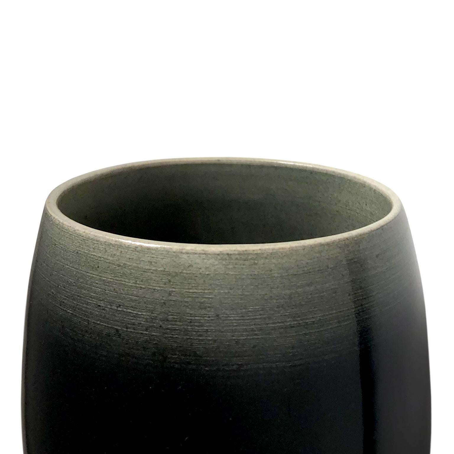 Tall dark ombre glaze ceramic chalice by Sandi Fellman, 2018. 

Veteran photographer Sandi Fellman's ceramic vessels are an exploration of a new medium. The forms, palettes, and sensuality of her photos can be found within each piece. The tactile