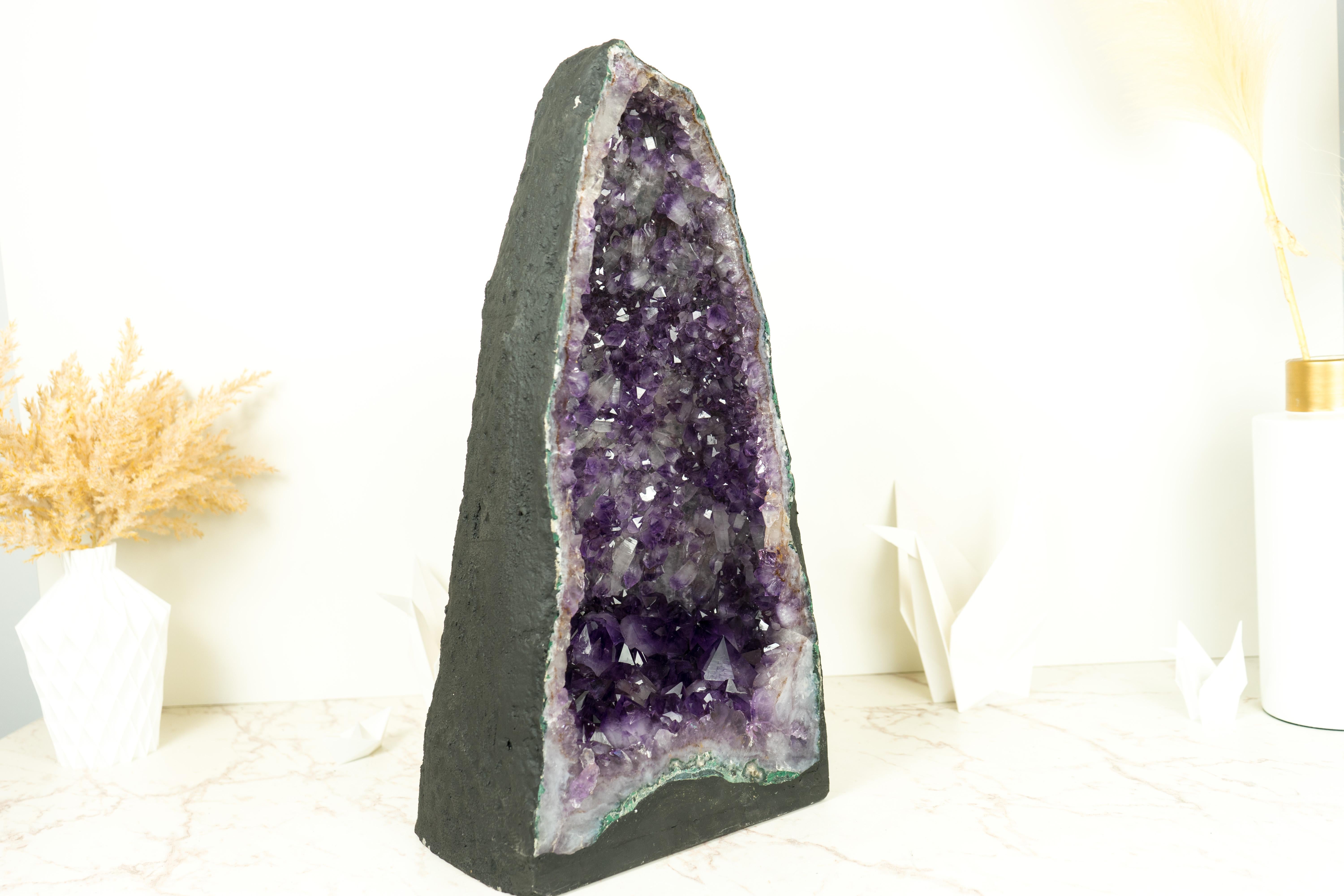 With its many qualities, including the rare Amethyst Druzy and its beautiful formation, this magnificent Amethyst Geode Cathedral is sure to add a pop of violet-purple color and a calming, peaceful atmosphere to your decor or crystal