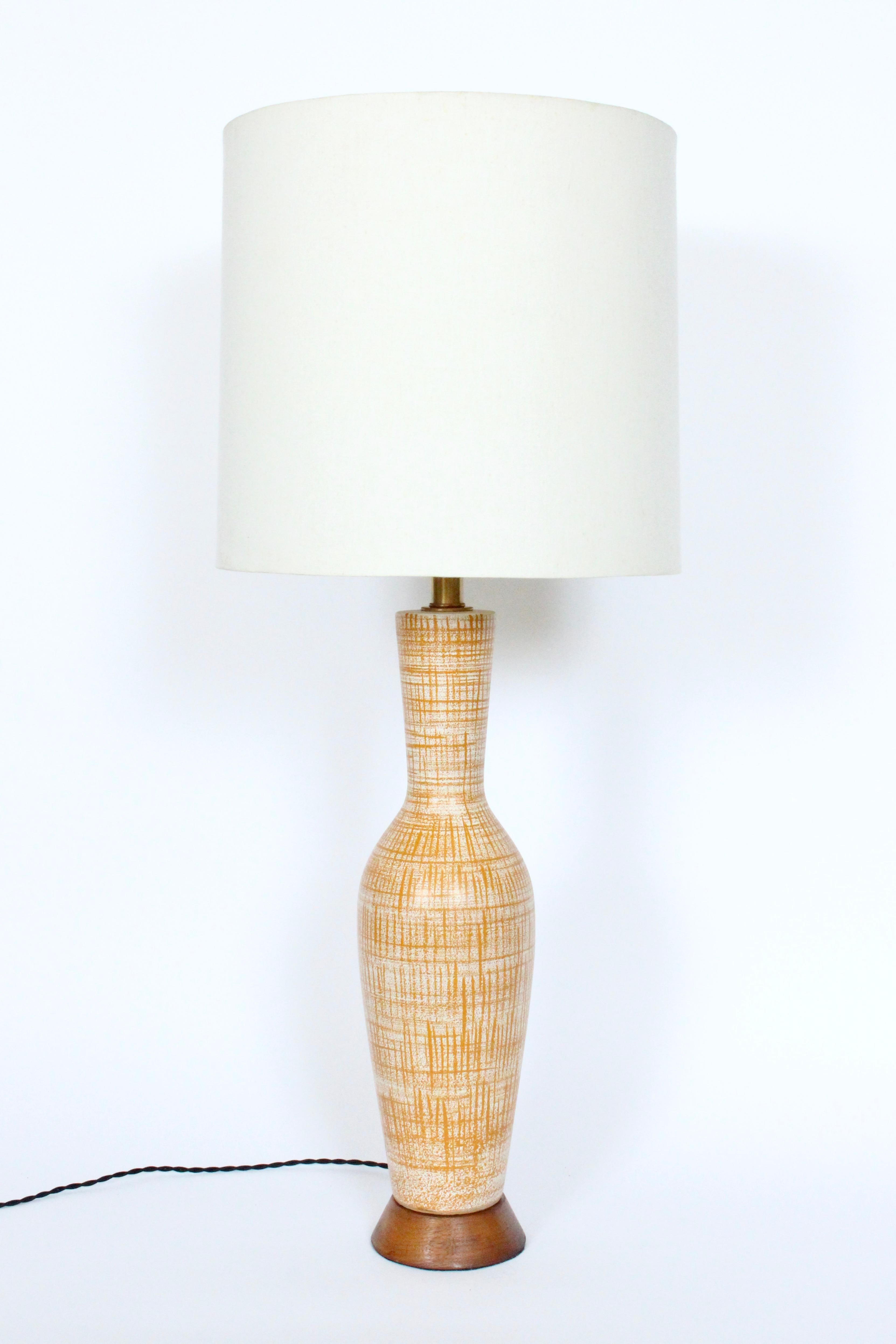 Monumental Design-Technics neutral glazed art pottery table lamp, 1960's. Featuring a pop of color on this classic handcrafted Design Technics Off White Ceramic form, hand painted with Dark Mustard Orange thinly lined criss cross pattern. A top a
