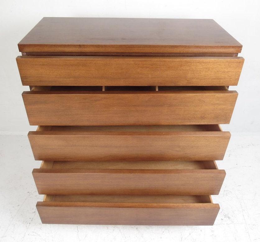 Tall chest of drawers in walnut by Bassett Furniture. Mid-century modern straight line design with five wide drawers.

Please confirm item location (NY or NJ).