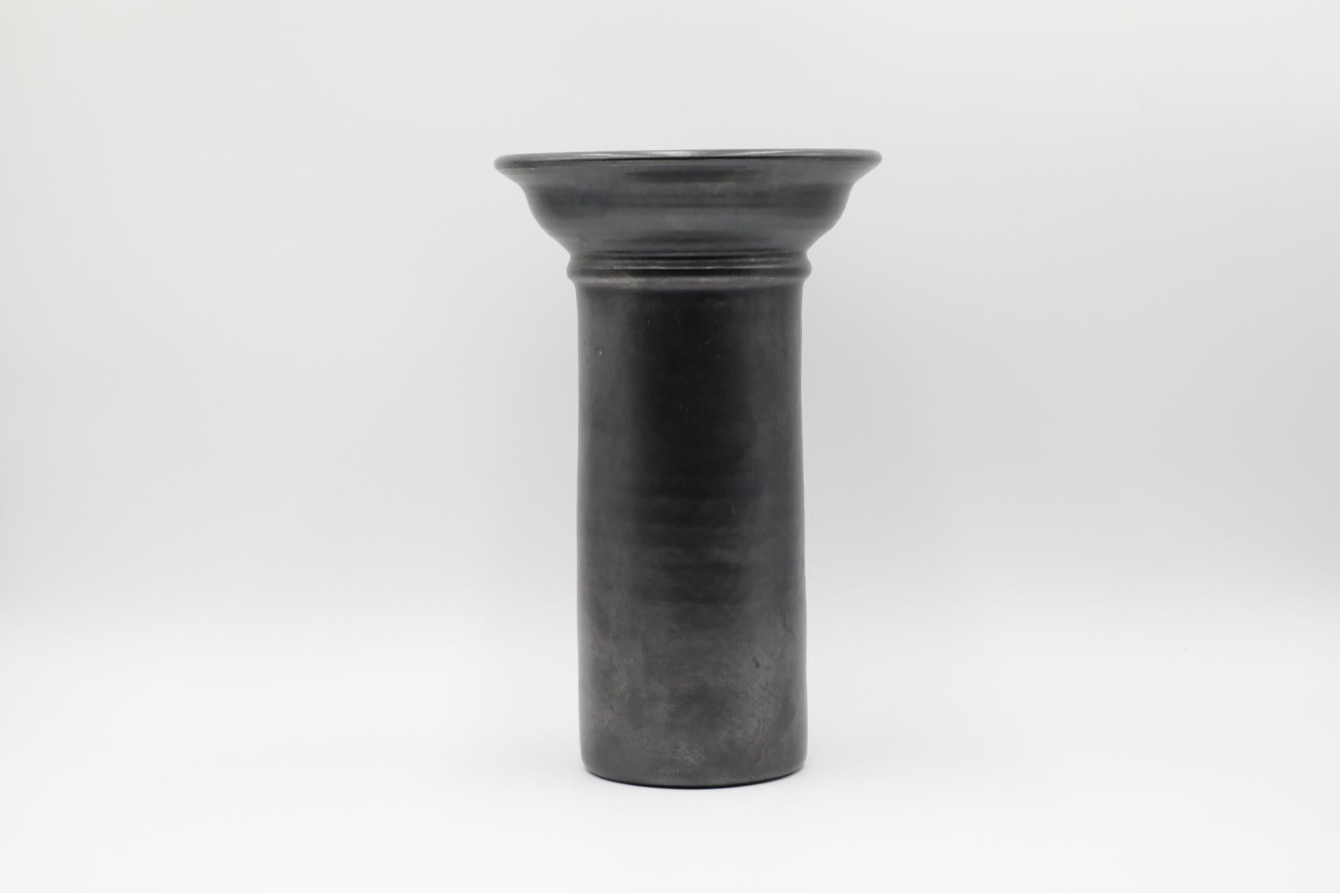 Excellent tall Dutch vase with black metallic glaze and wide neck and lip. No markings. Regarded as the golden age of ceramics, highly collectable 1950s-1970s Art Pottery is known for experimental and exploratory glazes, shapes, colors, and forms.