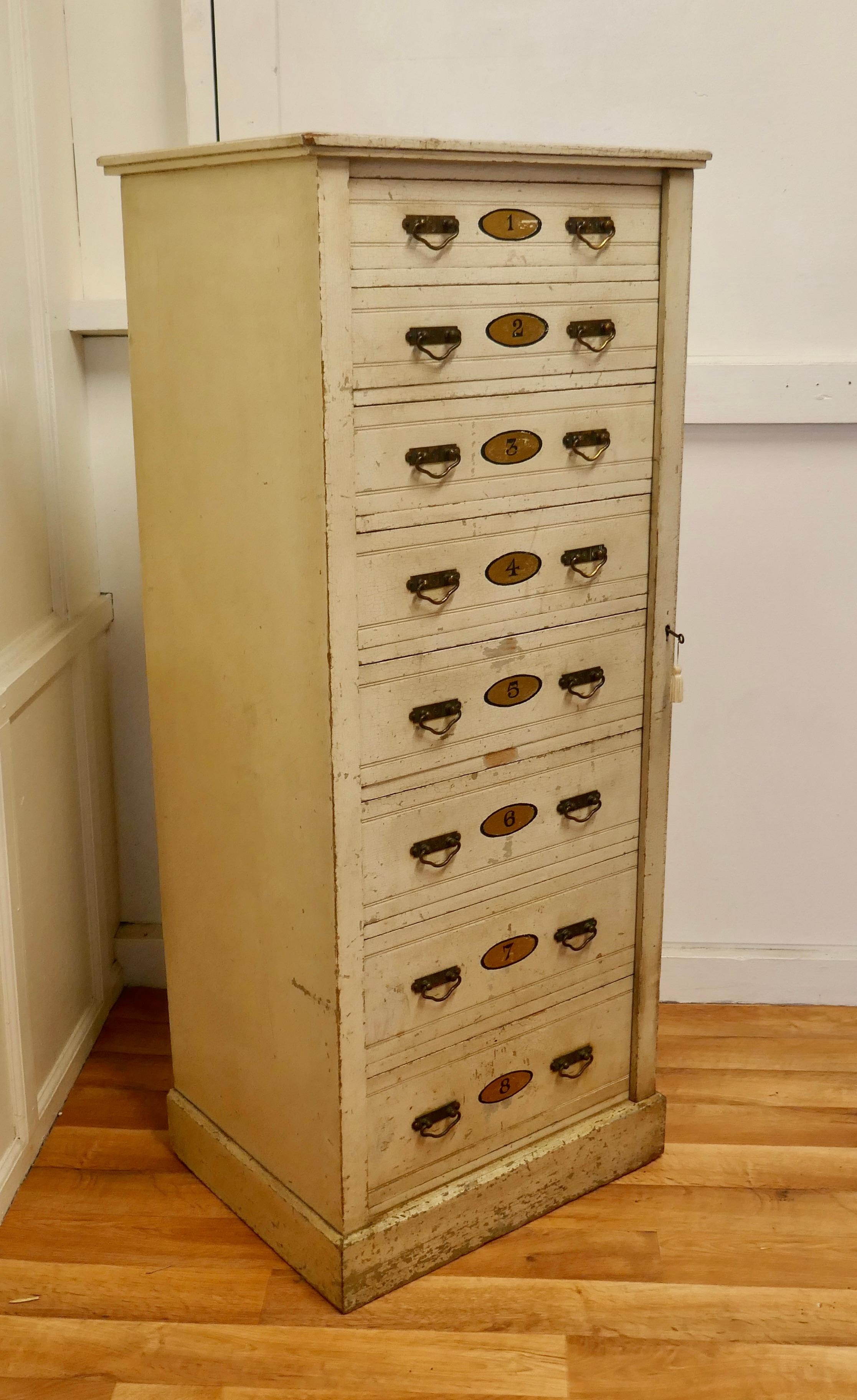 Tall Edwardian painted Wellington chest filing cabinet
 
The chest is full of character, it has an original painted finish, this is old with a crackle finish and the 8 drawers are all numbered on the front.
The cabinet is a heavy piece with a