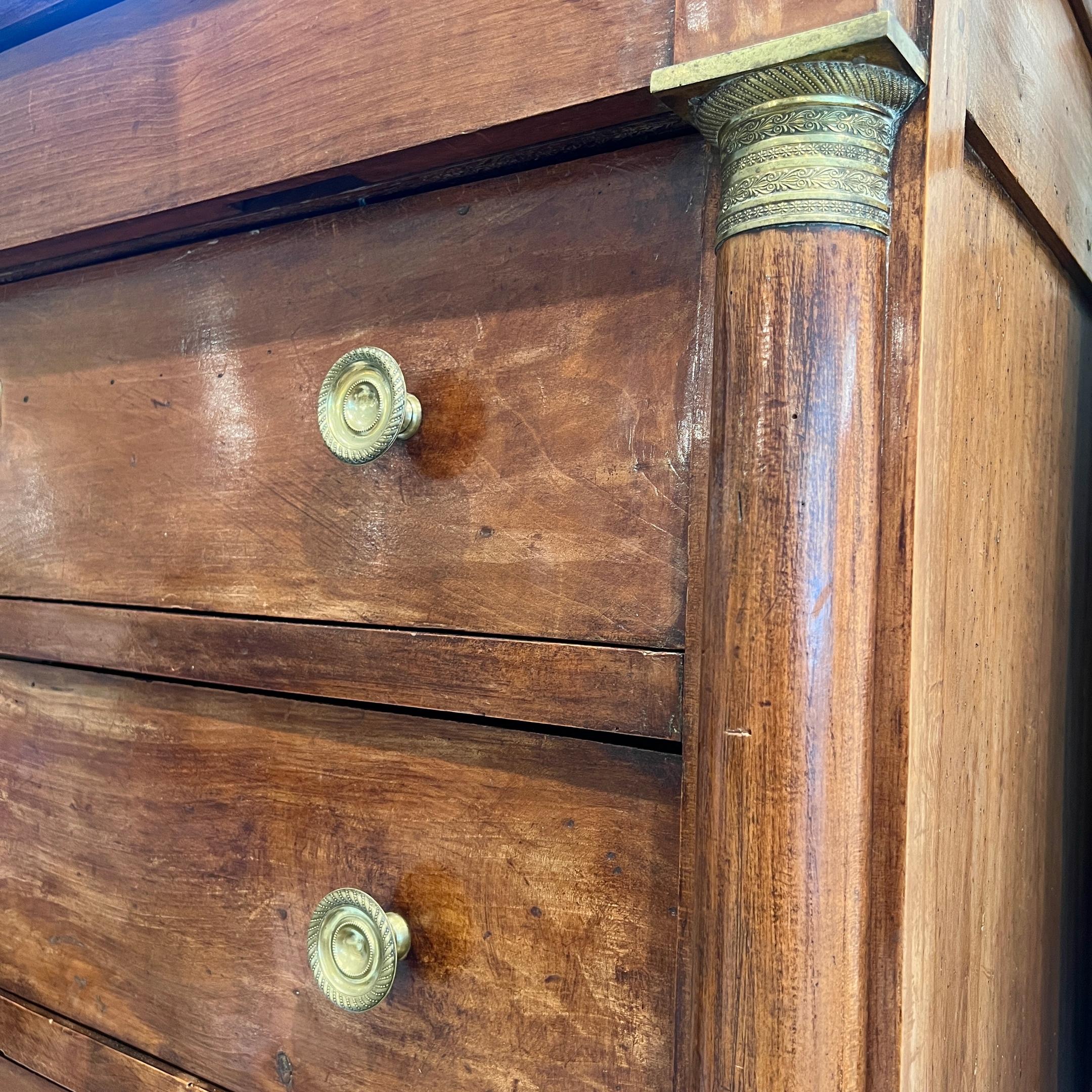 Tall chest of drawers with brass accents and pulls