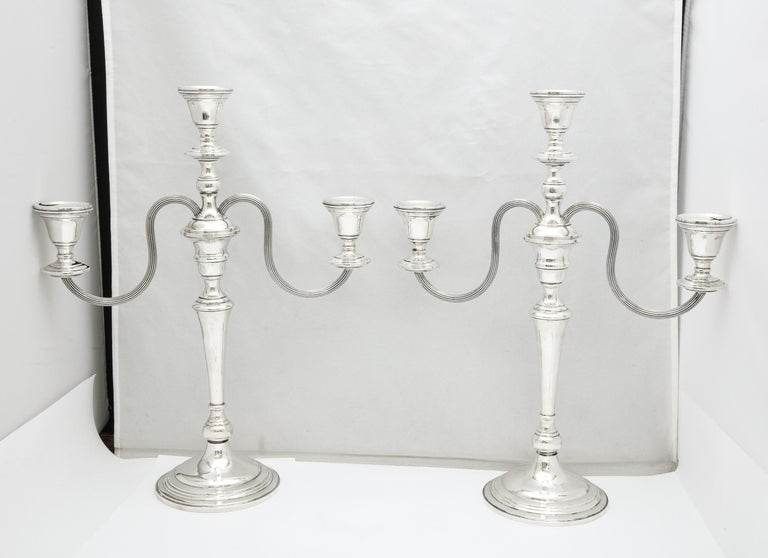 Tall, Empire-style sterling silver candelabra with removable arms, Preisner Silver Co., Wallingford, CT., Ca. 1935. Graceful design. Each of the pair, which is weighted, measures 15 1/4 inches high x 12 inches wide across the branch of each x 4