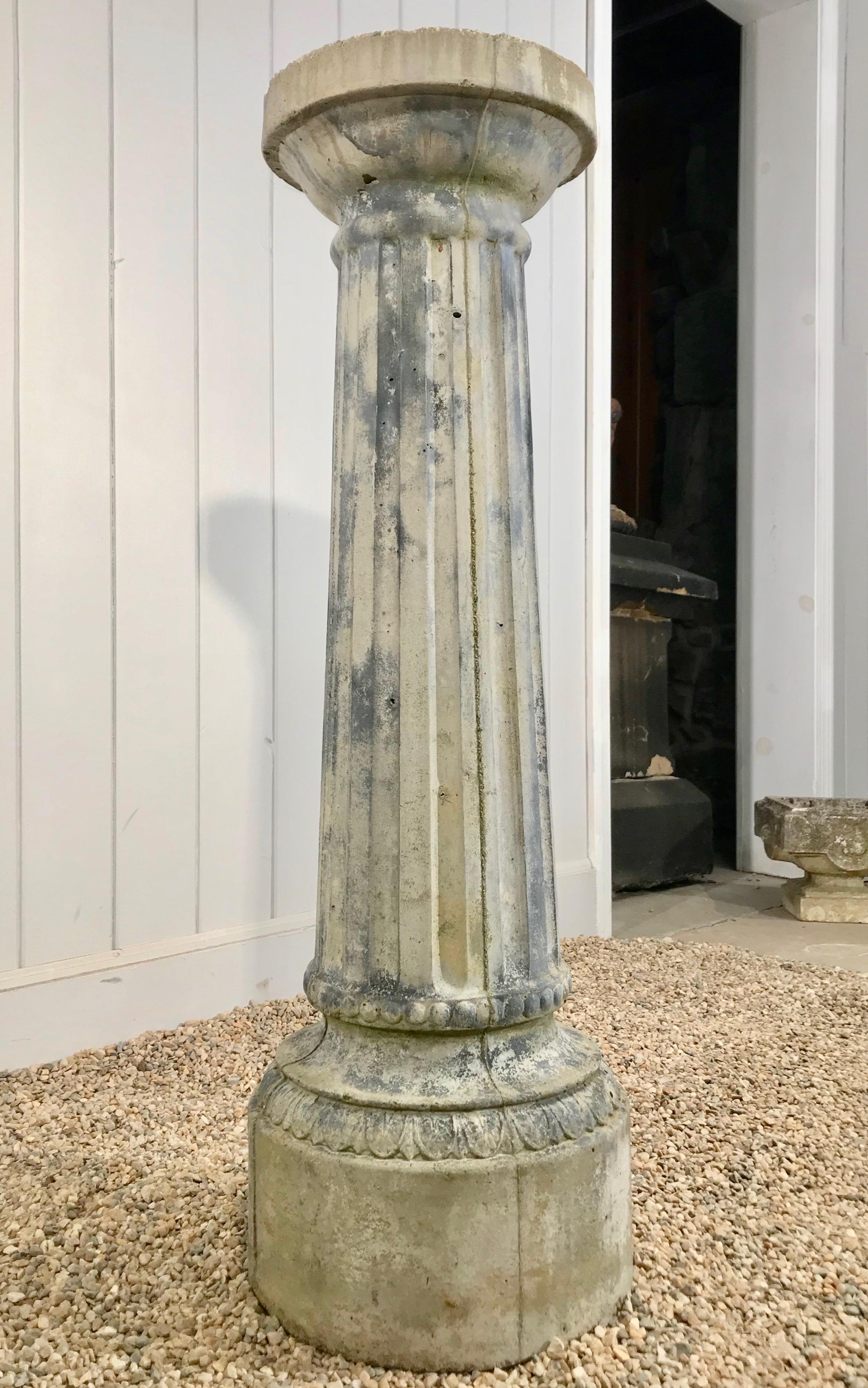 A very pretty faux-painted cast stone pedestal, this piece features a reeded center and graceful flared form. It would be striking in the garden with a small statue or abundantly-planted urn placed on its top. In excellent vintage condition, it has