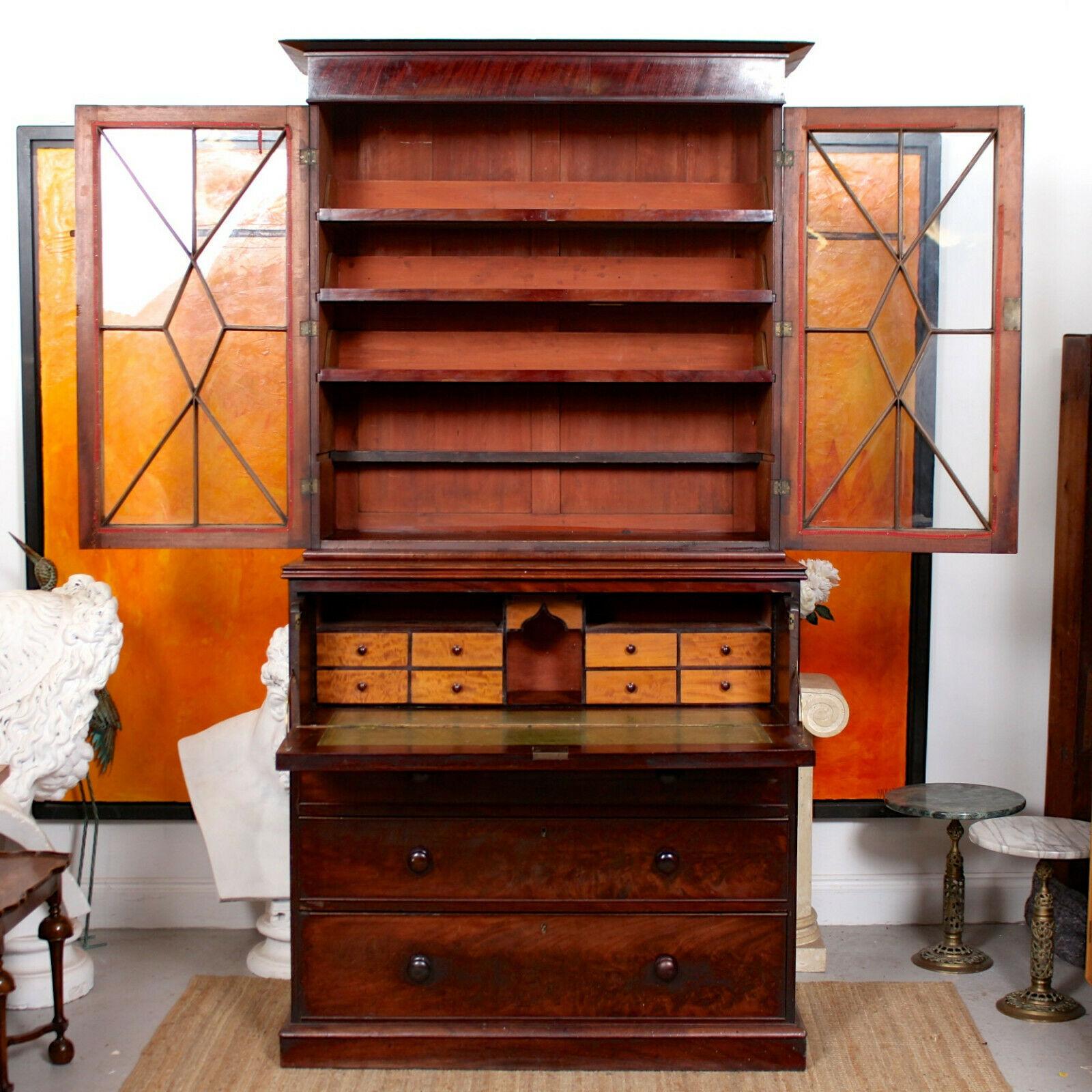 An attractive 19th century flamed mahogany glazed secrétaire.

The mahogany boasting a well figured flamed grain and rich patina.

The upper section with a projecting cornice above astragal glazed doors enclosed trays. The lower section with