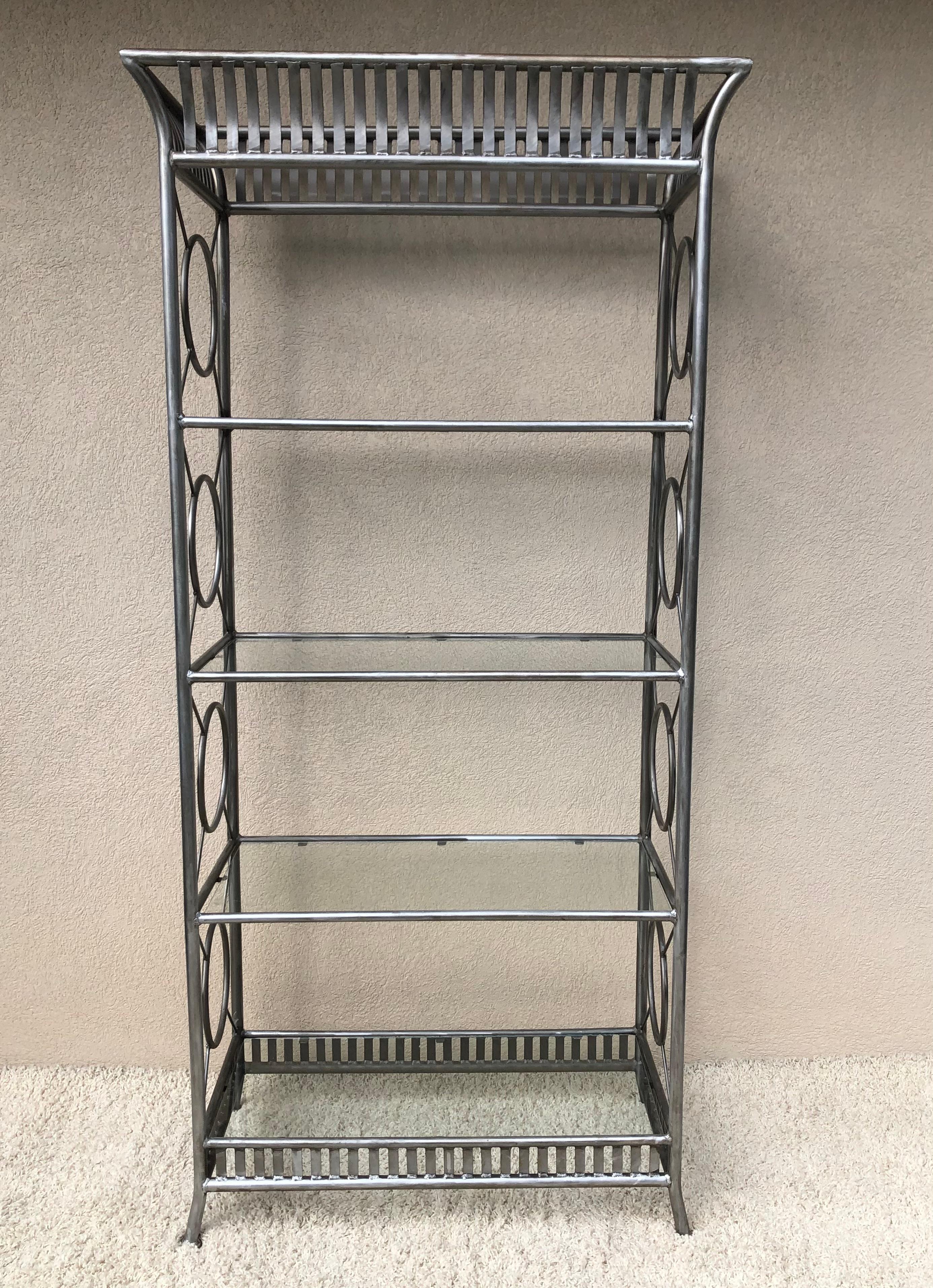 Tall Maison Jansen style Hollywood Regency, steel and glass etagere, elaborate hand made, with decorative top and base .unique size and scale. 5 glass shelves in all, vintage patina and condition. Silver tone to metal.