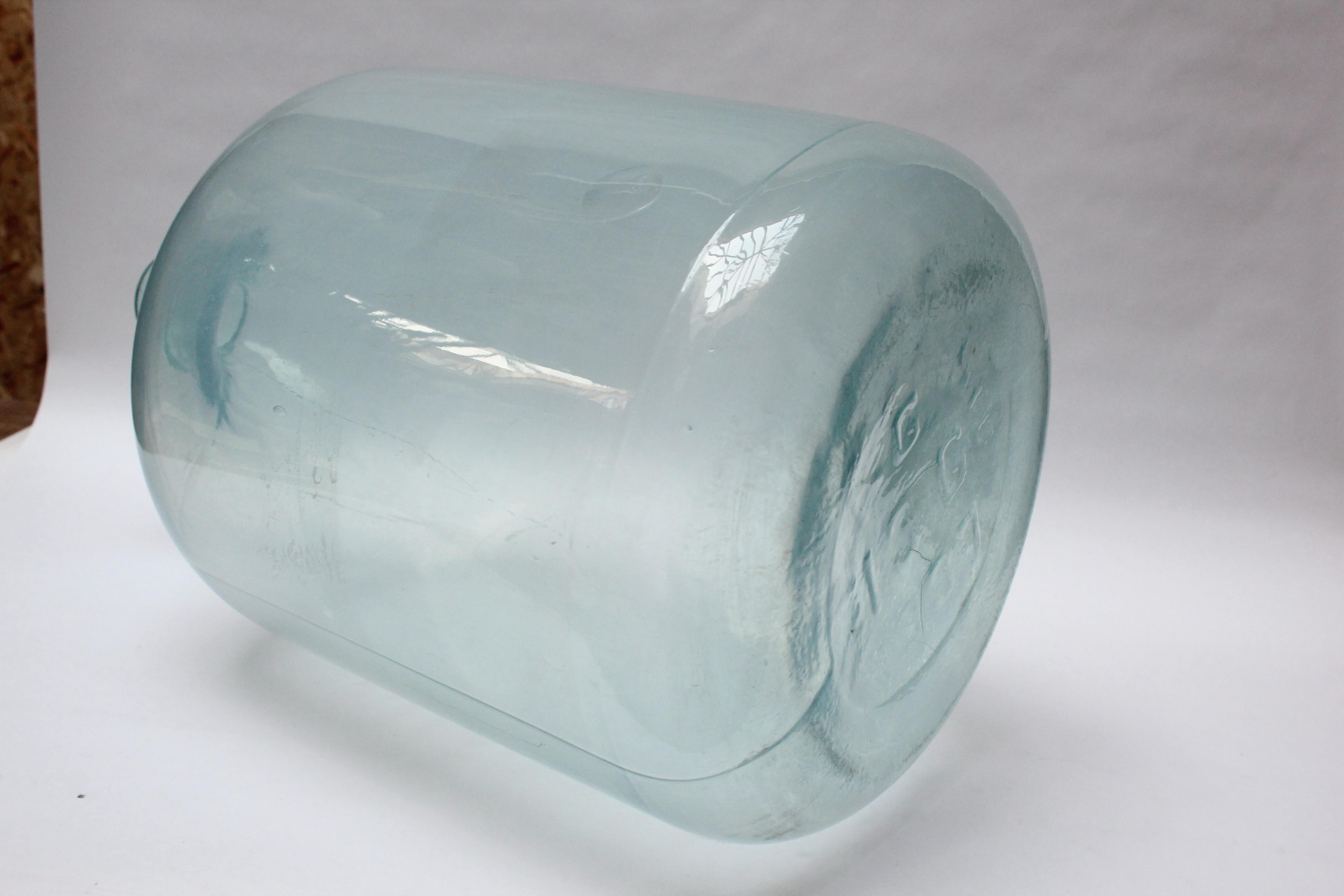 French Demijohn / Carboy originally used for transporting wine (1937 Century, Europe). Composed of molded and hand-finished ice-blue glass exhibiting trapped air bubbles within the glass itself. Unique color and form with a shorter lip and more