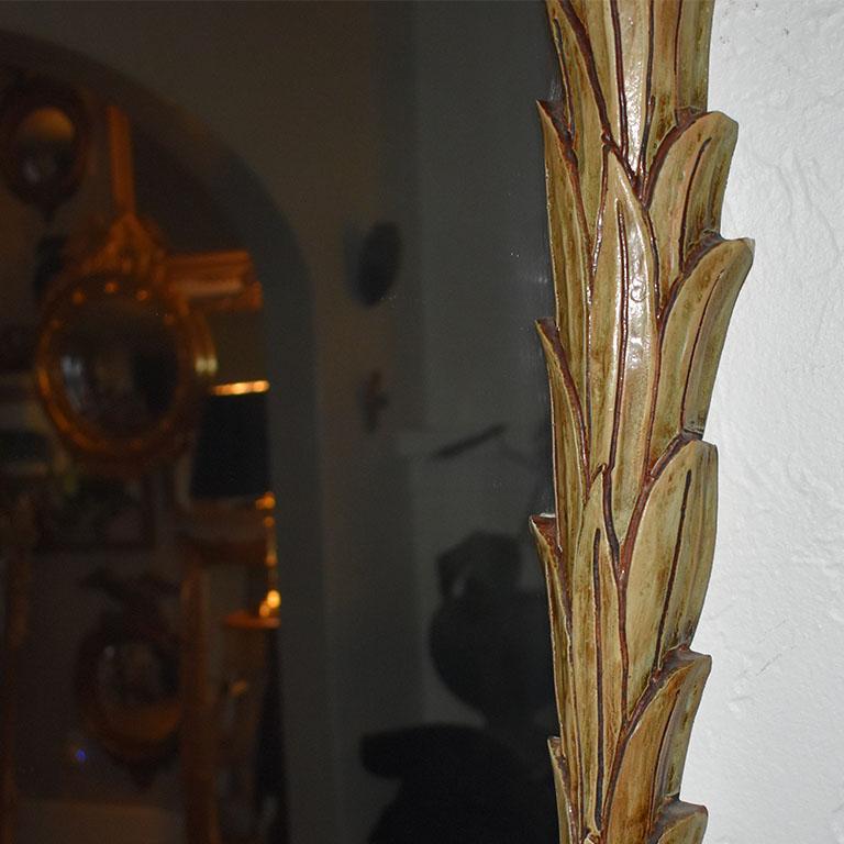 A tall faux bois wall or fireplace mantle mirror with a fern leaf motif. This lovely mirror will be the center of attention in any room. Hung vertically, the sides of the mirror are decorated in botanical leaves in brown. 

Dimensions:
49