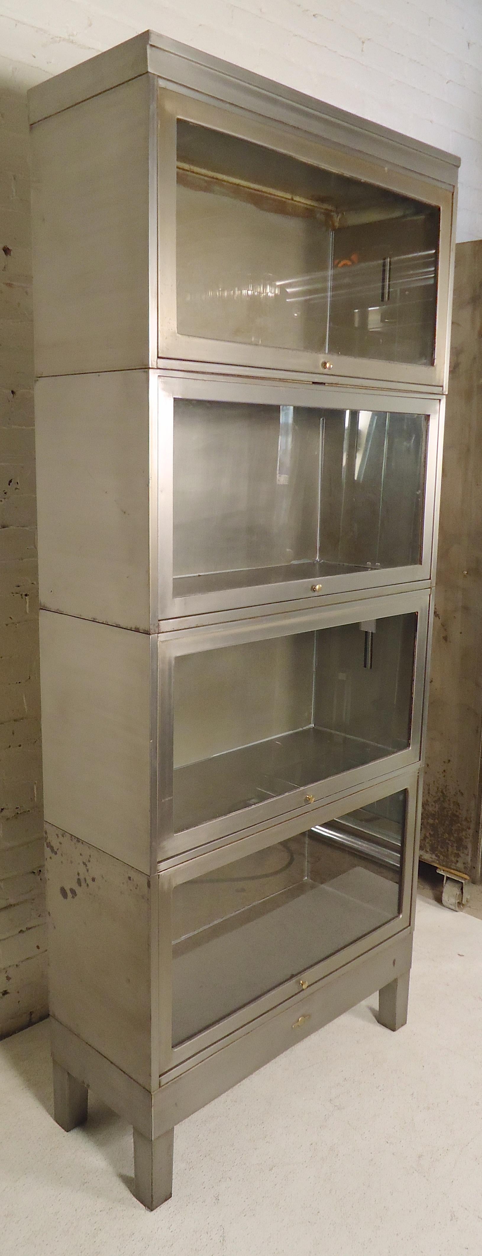 Industrial metal stacking bookcase restored in a bare metal style finish. Glass doors recess into each cabinet and close protecting your books and files.

(Please confirm item location - NY or NJ - with dealer).
 