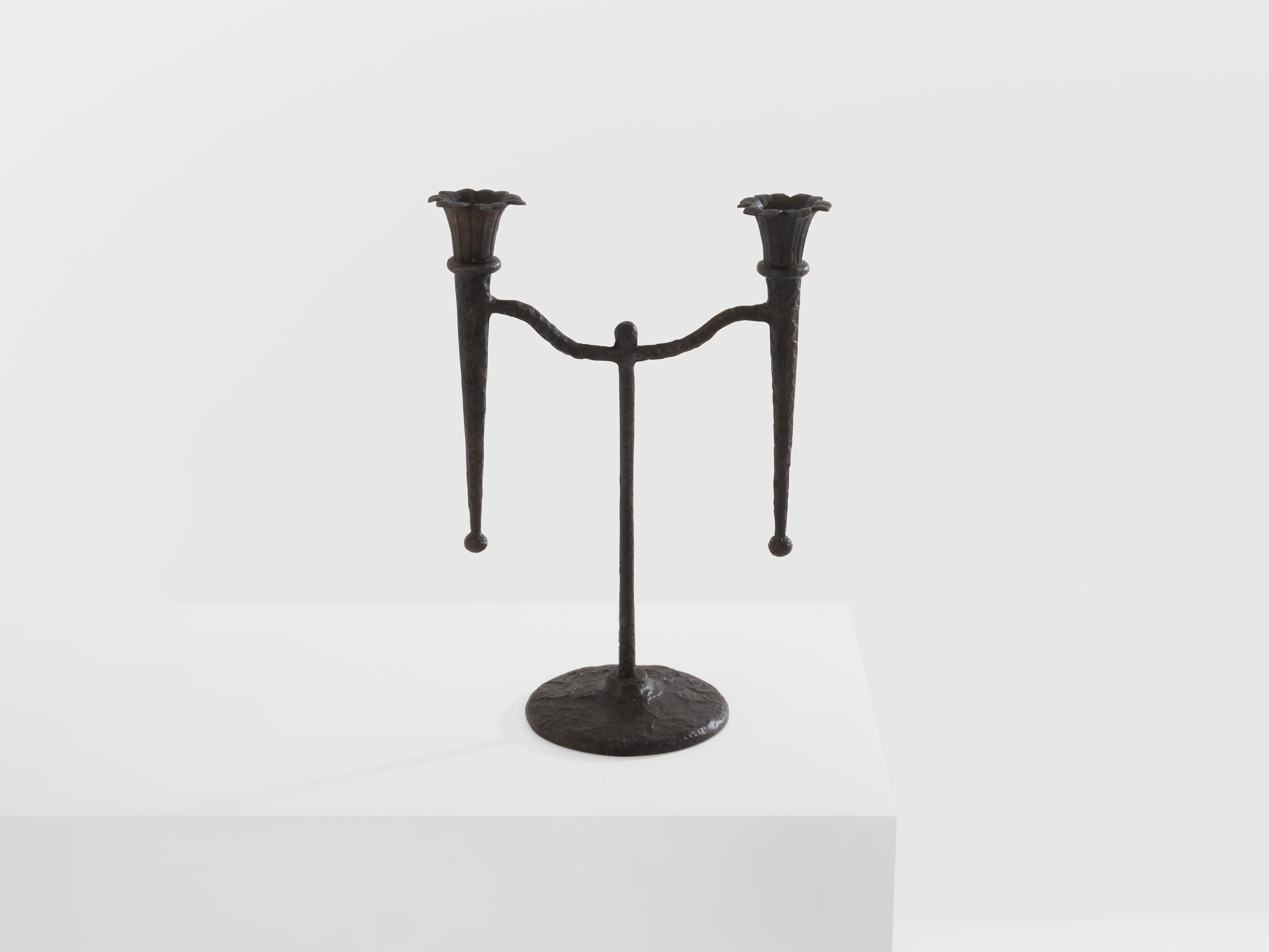 This French brutalist candlestick was made from bronze in the 1940s. bronze candle holder structure with two candle arms and a round foot. Beautiful vintage condition, with a very nice patina to the bronze work.