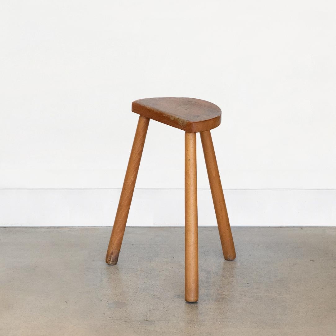 Tall vintage wood stool with semi-circle seat from France. Original light oak finish with great age markings and patina. Perfect as a stool or a side table next to chairs.