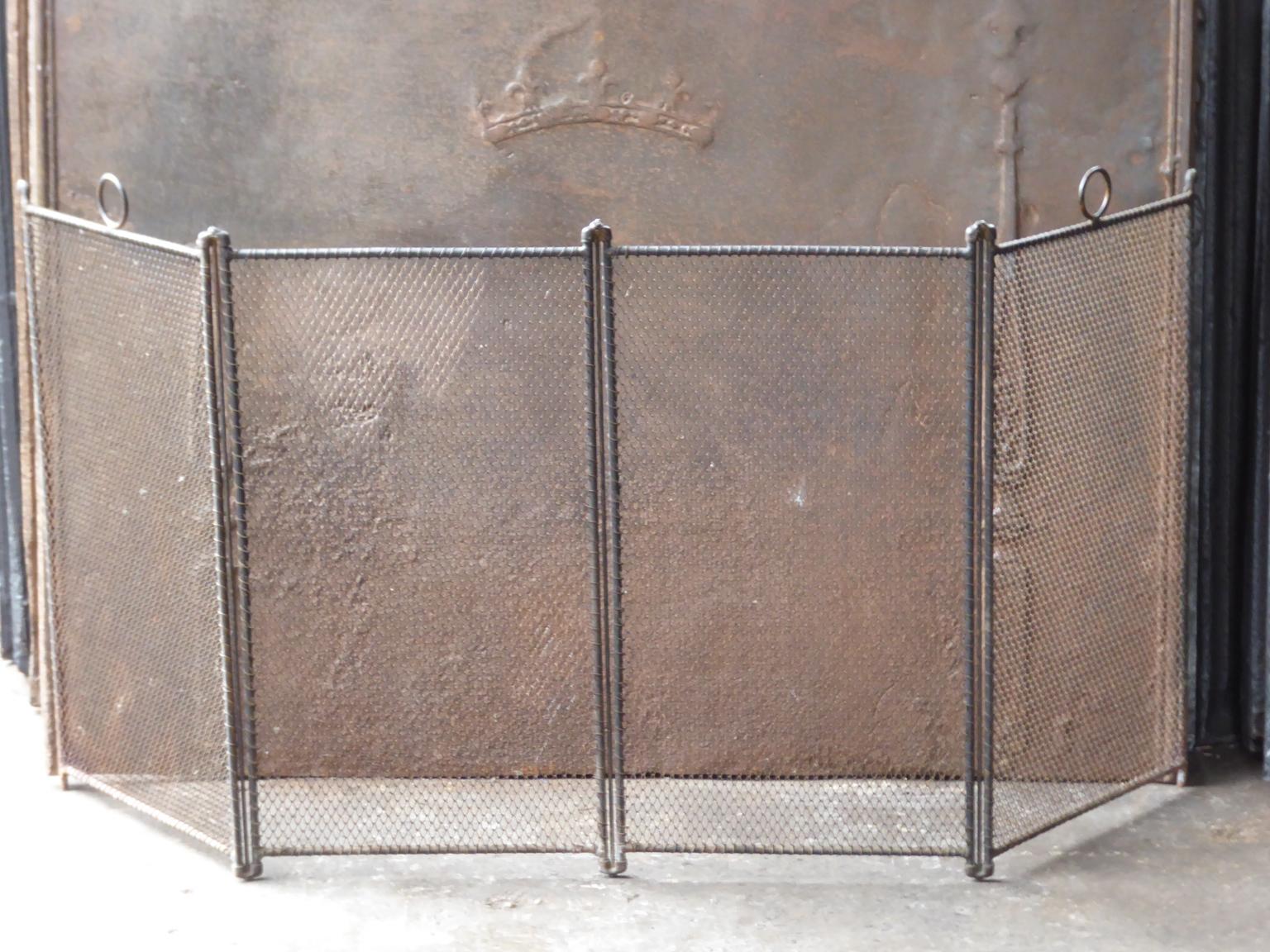 Tall French four-panel fireplace screen. The period is 19th century, Napoleon III. The screen is made of wrought iron and iron mesh. It is in a good condition and is fit for use in front of the fireplace.