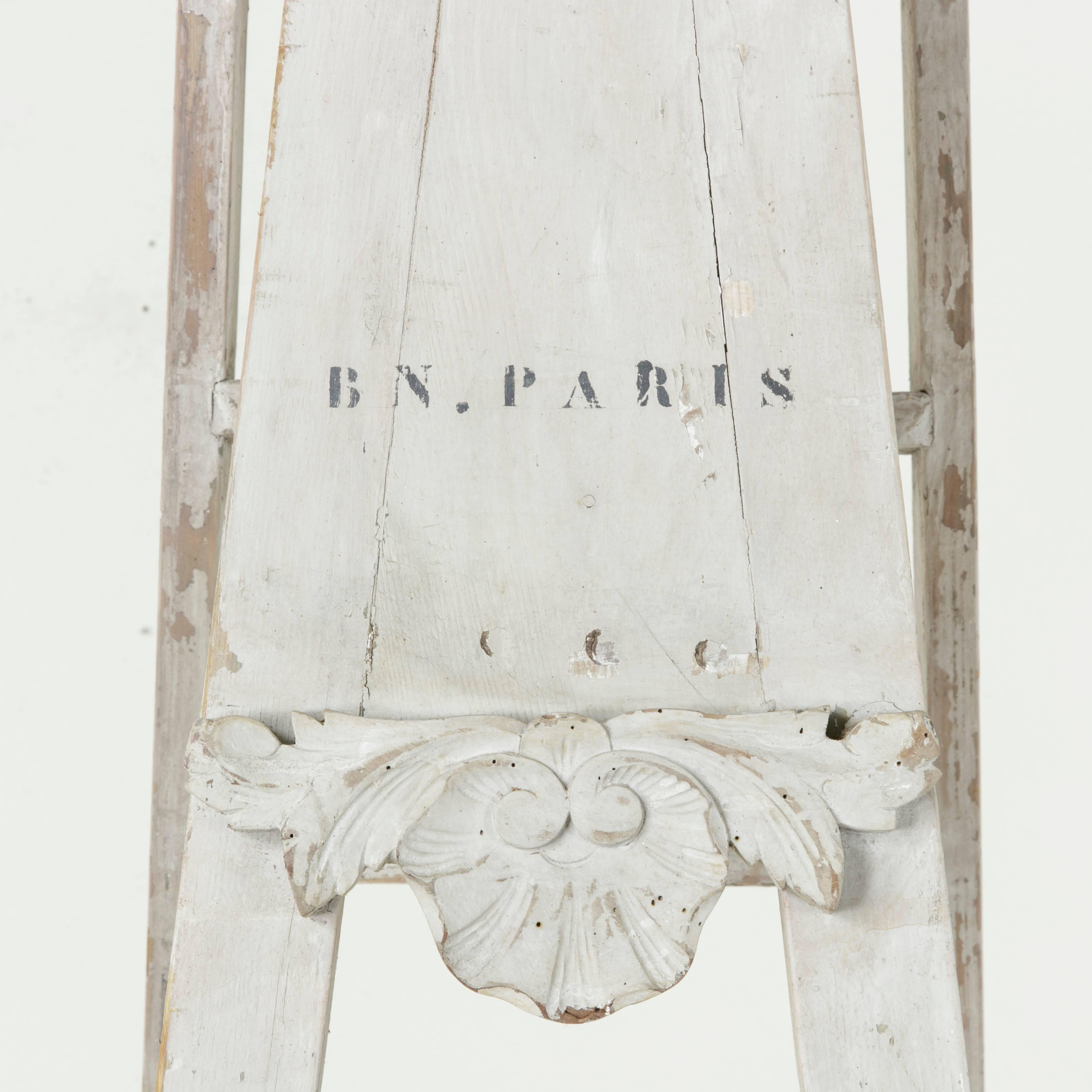 An historic find, this very tall painted folding library ladder is marked B.N. Paris from the Bibliothe`que Nationale de Paris and stands at just over six and a half feet in height. It folds flat for easy moving. This piece was originally used in