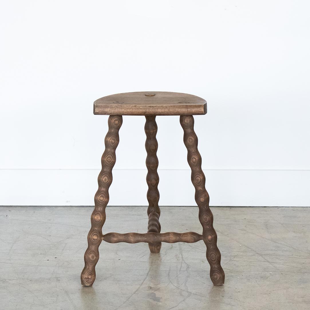 Vintage tall wood stool with semi-circle seat and wavy tripod legs from France. Original wood finish with great age markings and patina. Can be used as a stool or as side table next to chairs. 

 