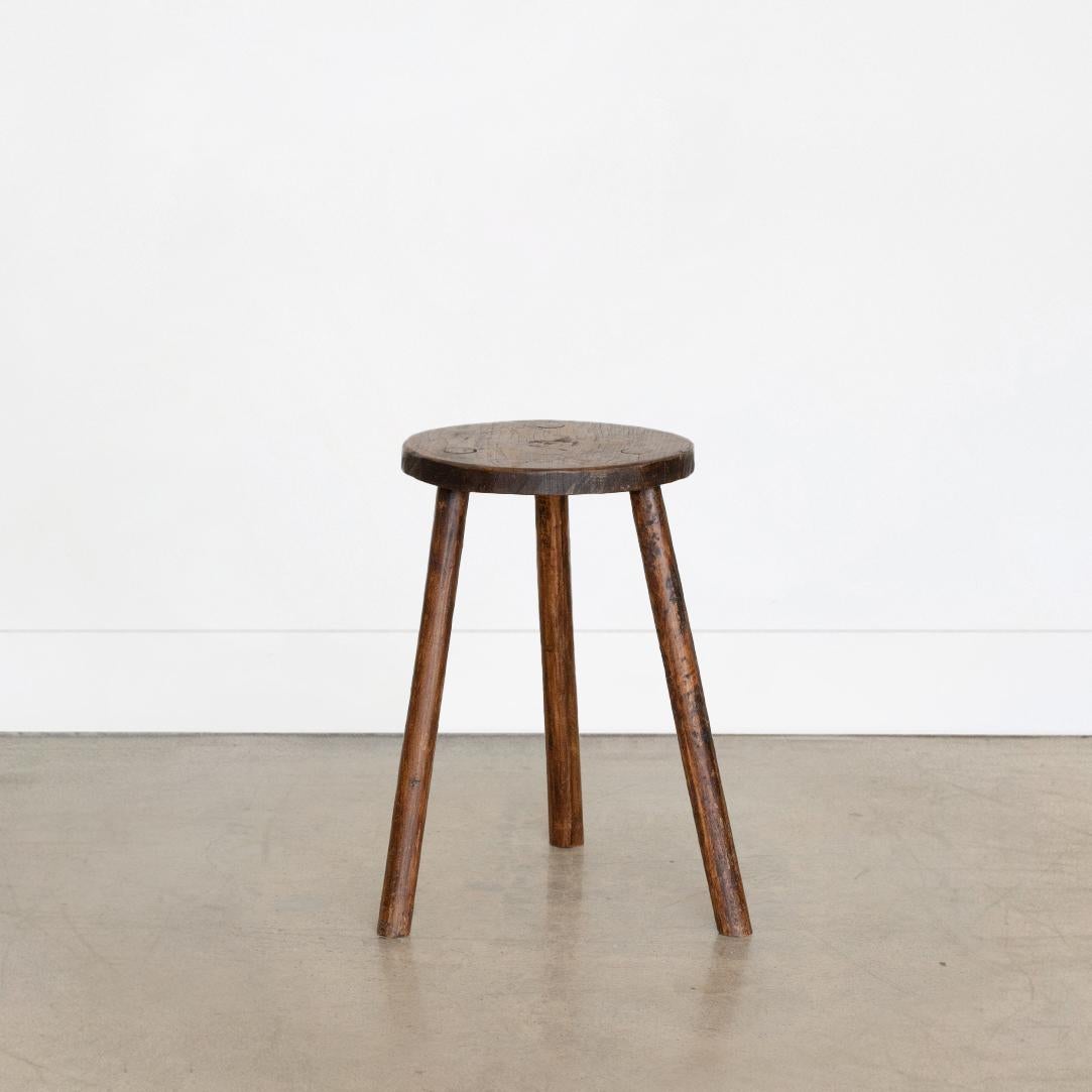 Vintage tall wood stool with circular seat and tripod legs from France. Original wood finish with great age markings and patina. Can be used as a stool or as side table.



