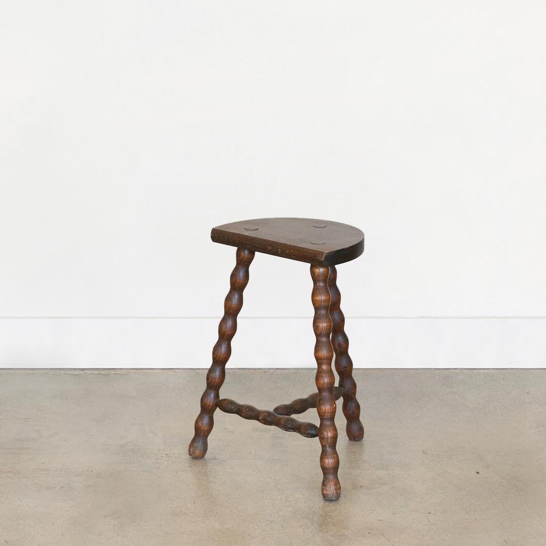 Vintage tall wood stool with semi-circle seat and wavy tripod legs from France. Original wood finish with great age markings and patina. Can be used as a stool or as side table.