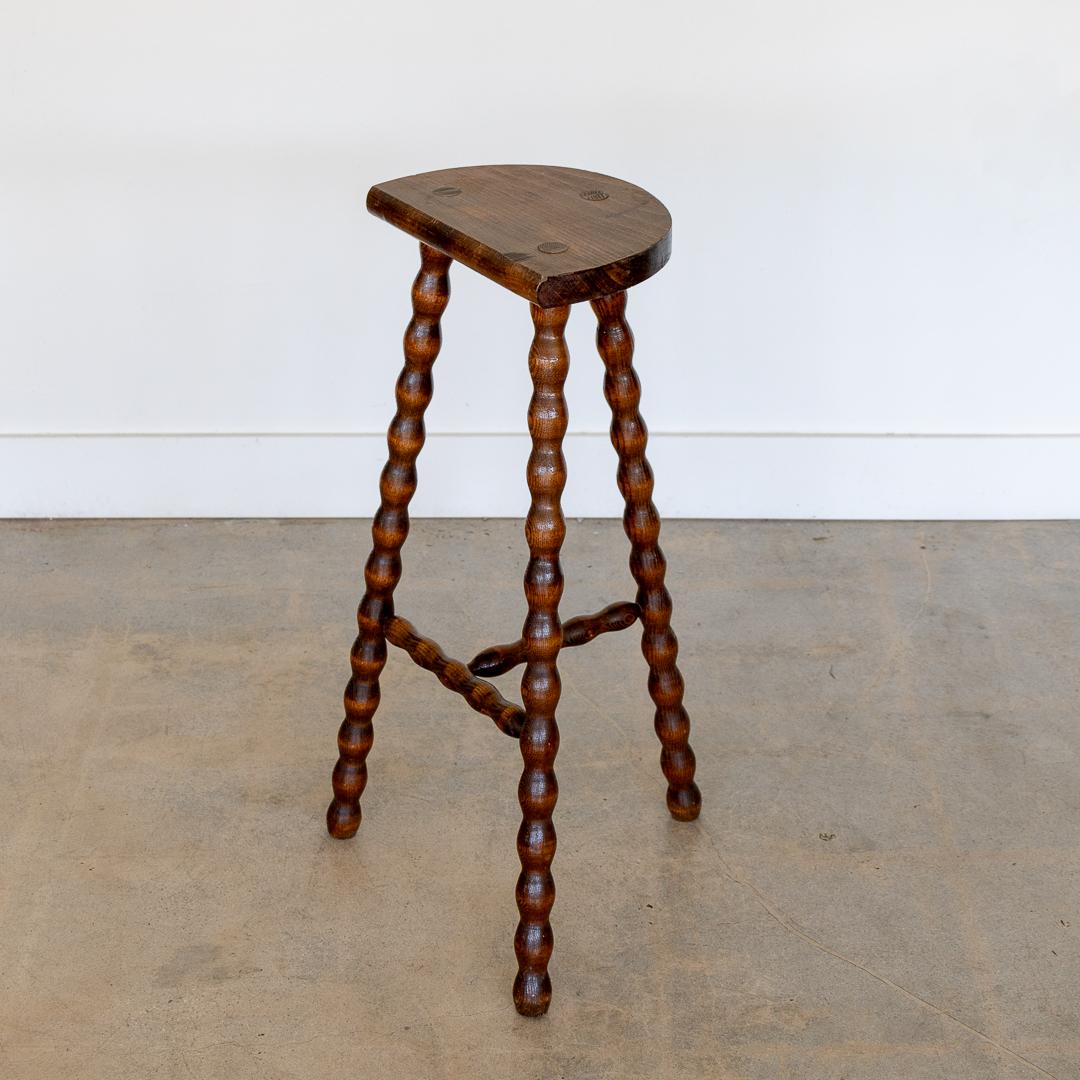 Vintage extra tall wood stool with semi-circle seat and wavy tripod legs from France. Original wood finish with great age markings and patina. Can be used as a stool or as side table. 



