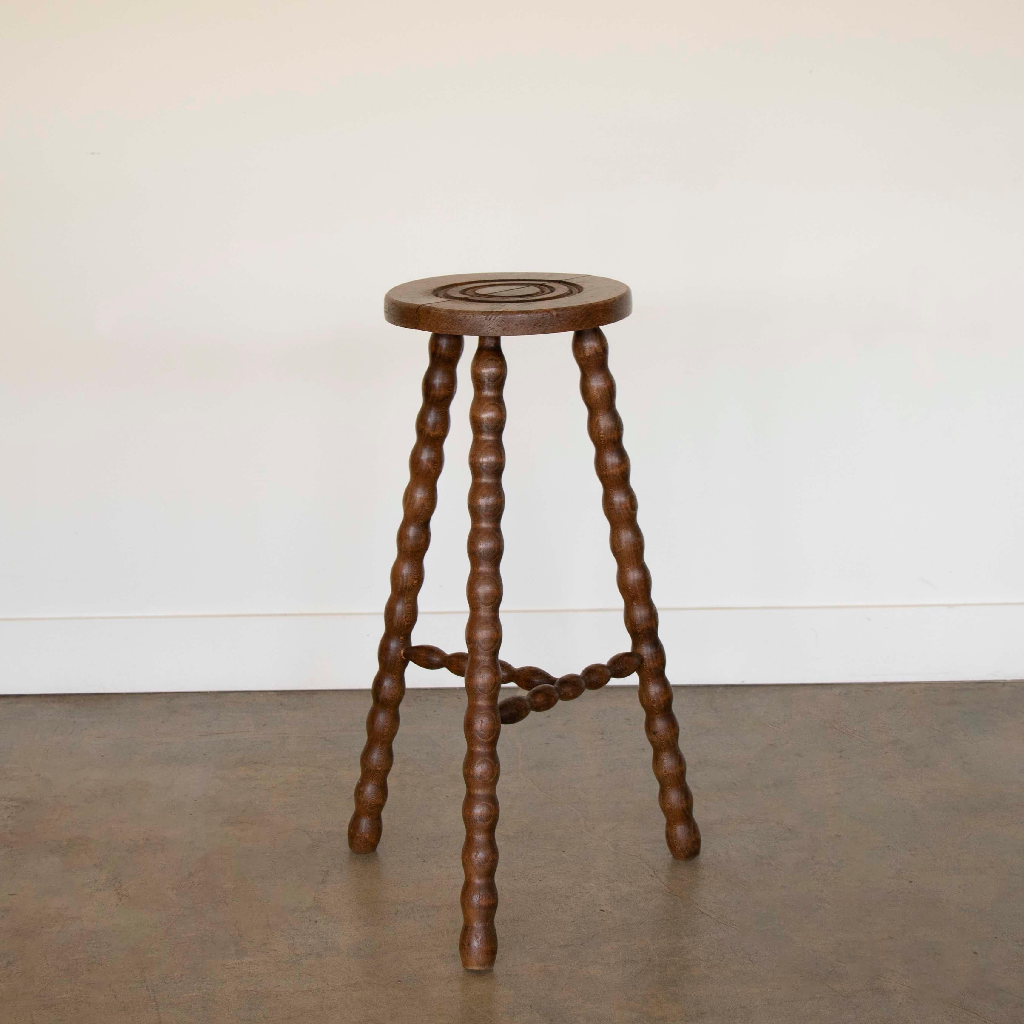 Vintage wood stool with beautiful wavy wood legs from France. Circular seat with unique carved ring detail on top. Original wood finish with great age markings and patina. Can be used as stool or as a side table. 