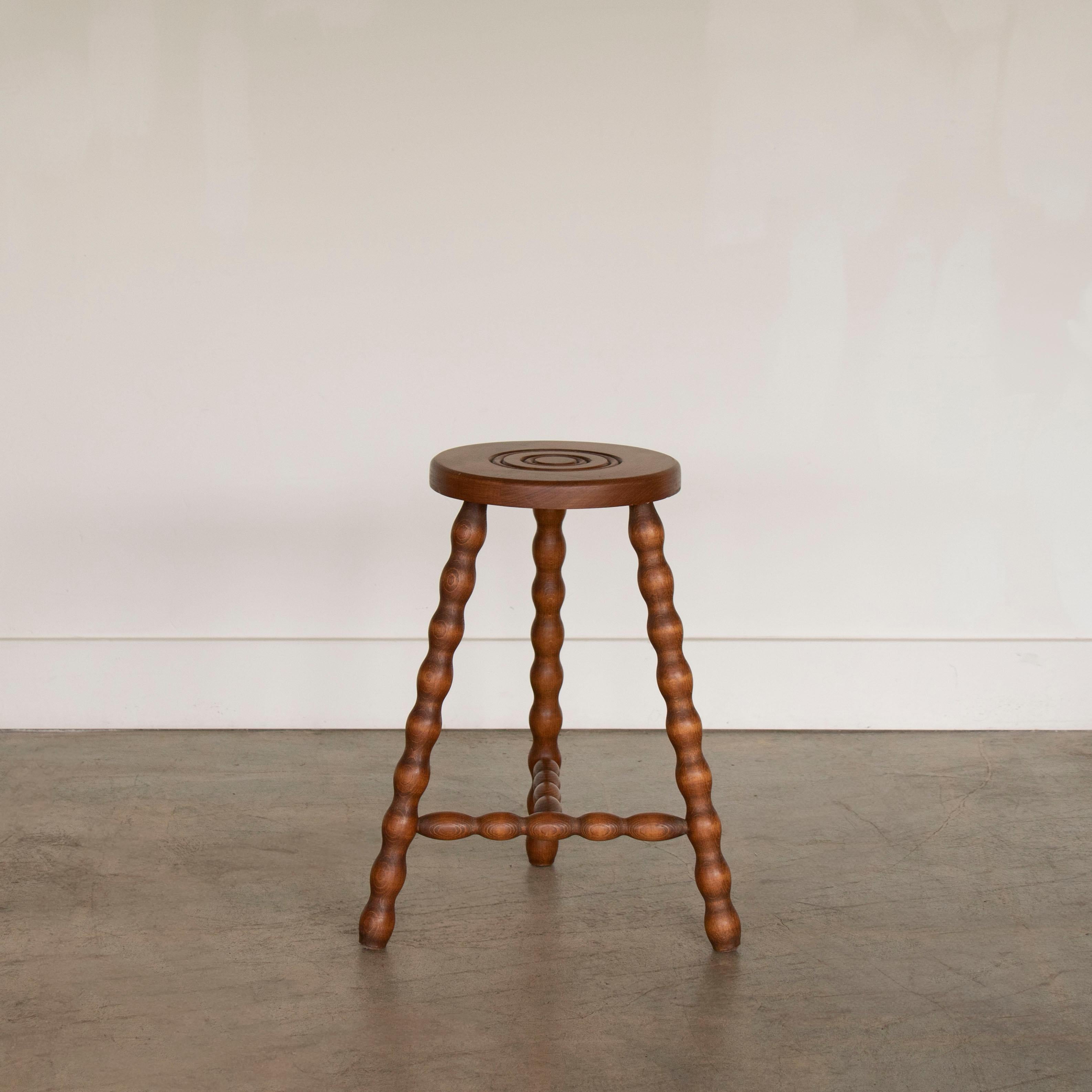 Vintage wood stool with beautiful wavy wood legs from France. Circular seat with unique carved ring detail on top. Original wood finish with nice age markings and patina. Can be used as stool or as side table next to chairs. 