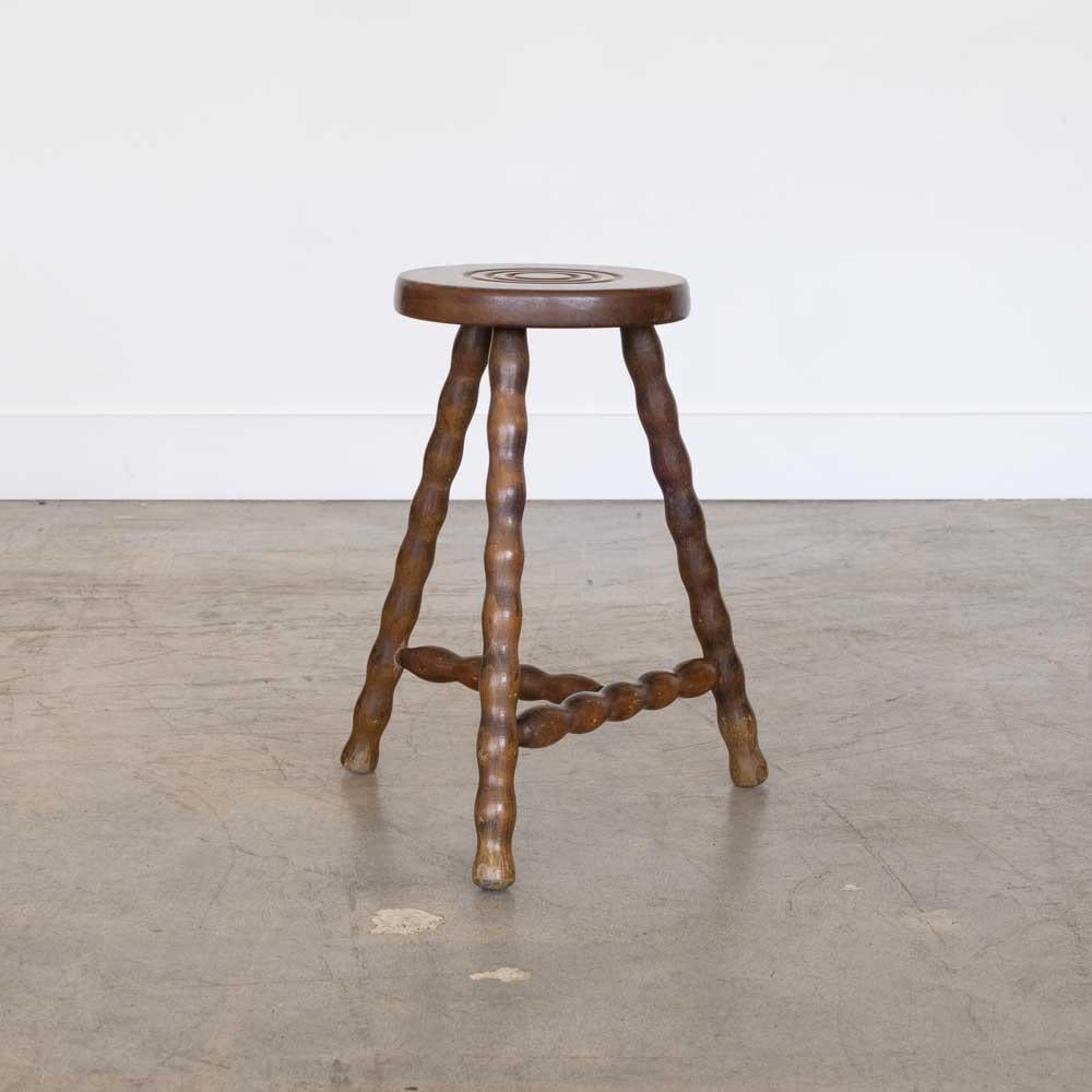 Vintage wood stool with beautiful wavy wood legs from France. Circular seat with unique carved ring detail on top. Original wood finish with nice age markings and patina. Can be used as stool or as side table next to chairs. 