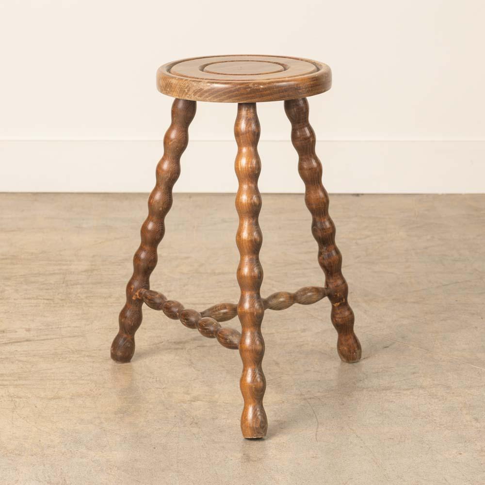 Sgabello vintage in legno con belle gambe in legno ondulato proveniente dalla Francia. Sedile circolare con particolare anello intagliato sulla parte superiore. Finitura originale in legno con bei segni dell'età e patina. Può essere utilizzato come