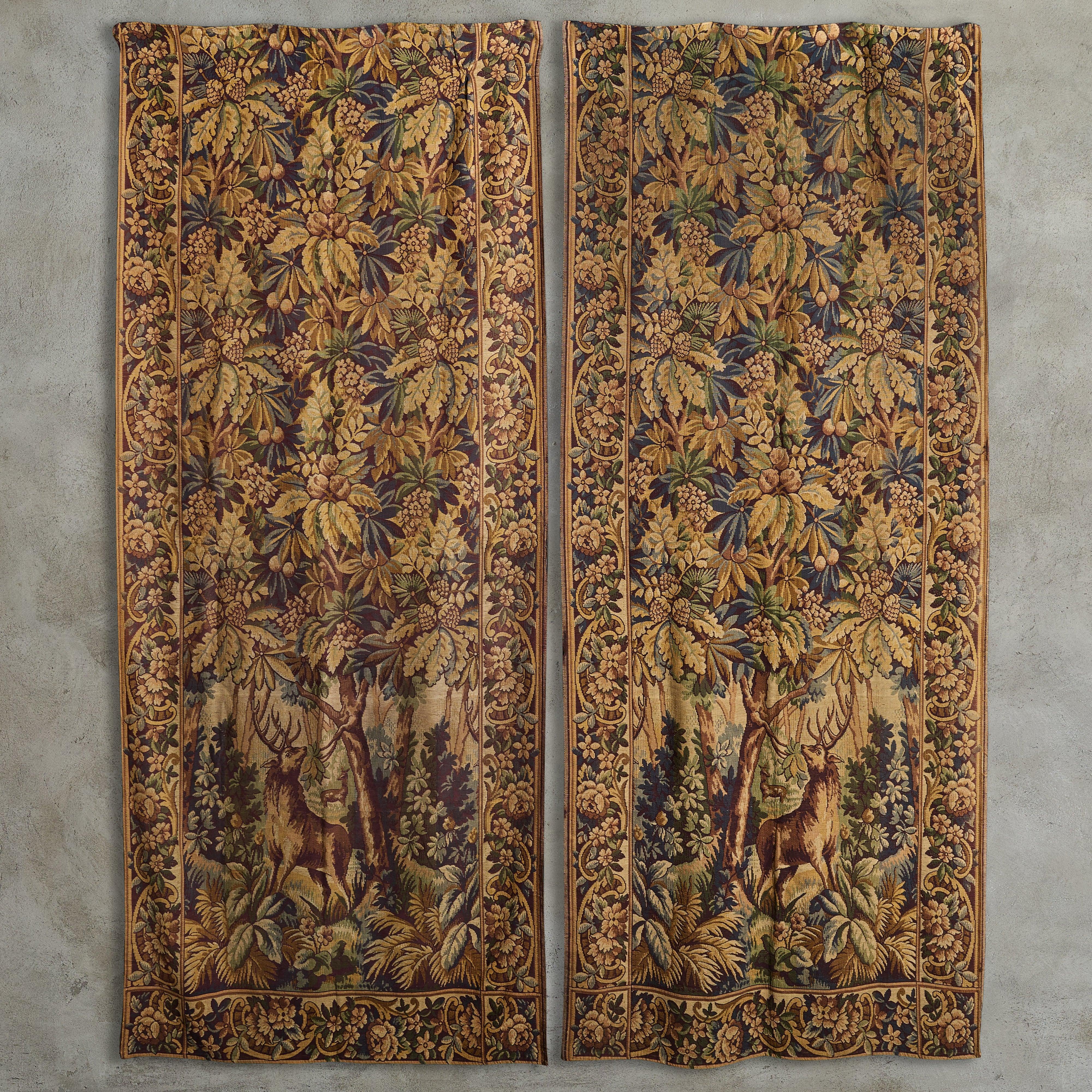 A tall 1920s French tapestry featuring a lush woodland scene with foliate and deer motifs in brown and taupe hues. Time-worn patina enhances its storied beauty. Sourced in France, 1920s.

Sold and priced individually.
Great vintage condition. One of