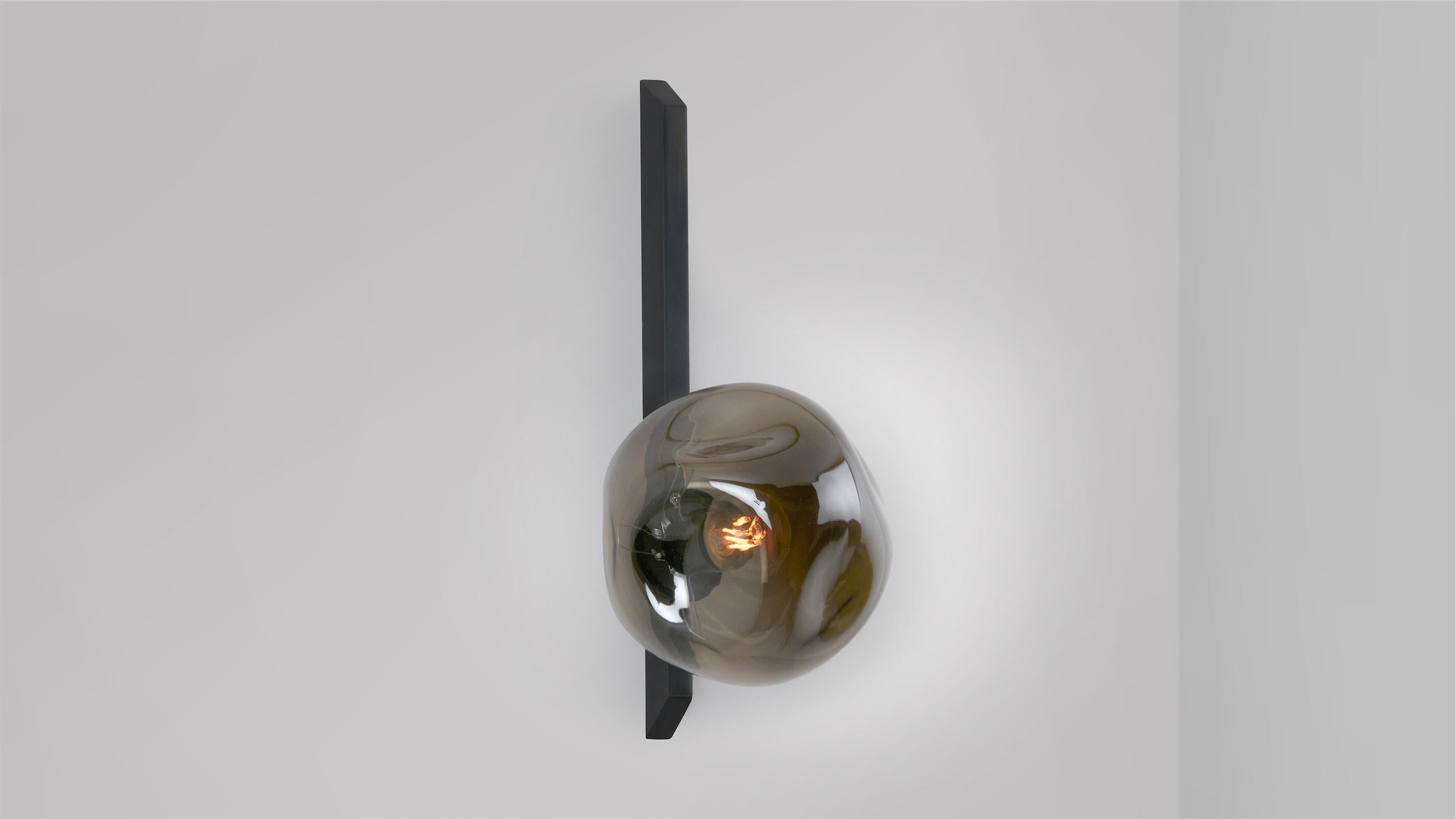 Tall Gaia wall lamp by CTO Lighting
Materials: Bronze with hand-shaped smoked glass.
Dimensions: D 18.3 x W 15 x H 35 cm
Available in bronze or satin brass and in hand shaped smoke glass, matte opal glass, shiny opal glass, or tinted glass. 

An