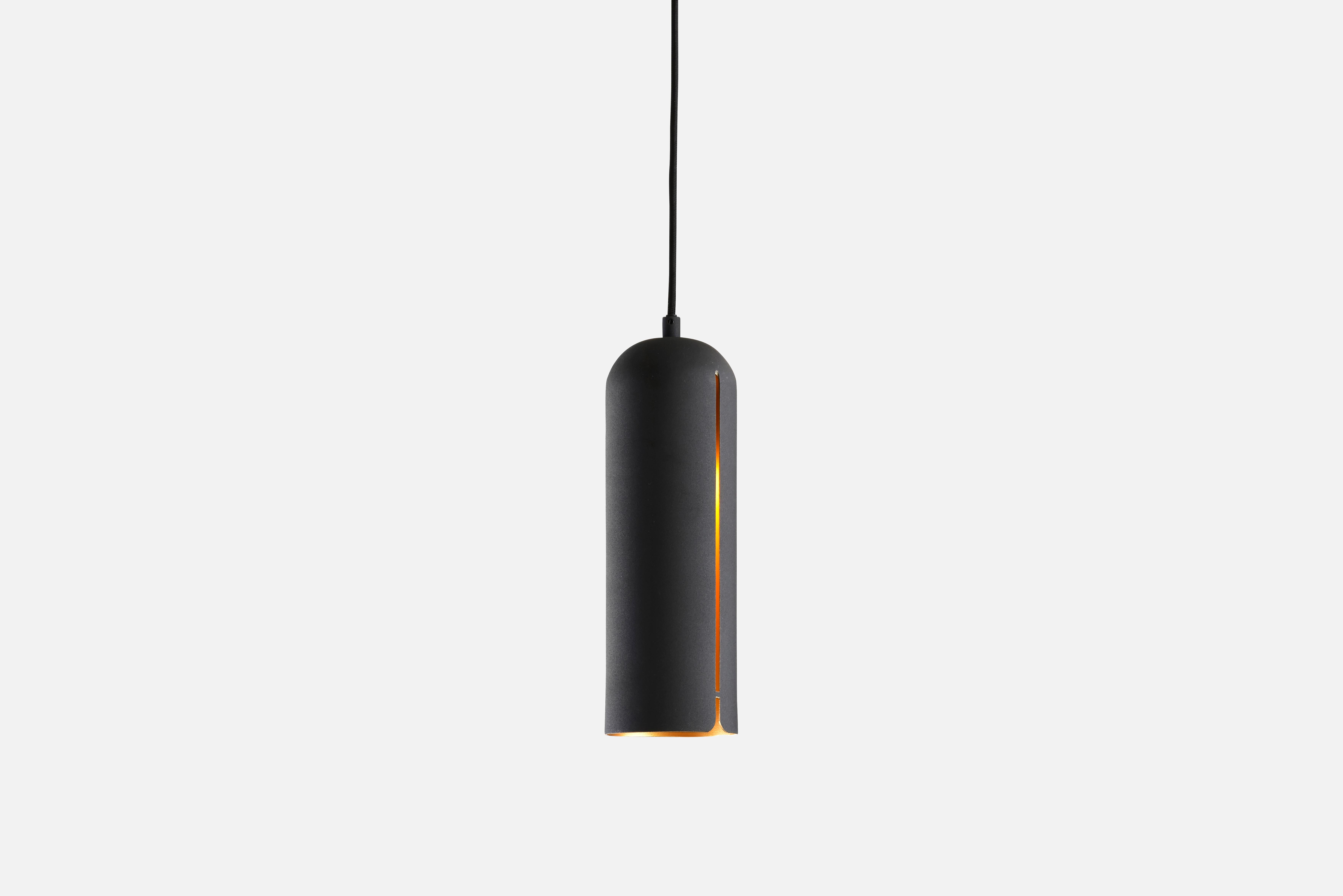 Tall gap pendant lamp by Nur Design
Materials: Metal.
Dimensions: D 10 x H 30 cm

NUR design is a Danish design studio focusing on Nordic traditions with a strive to create classic and functional design. In German, the word NUR means ‘only’ and