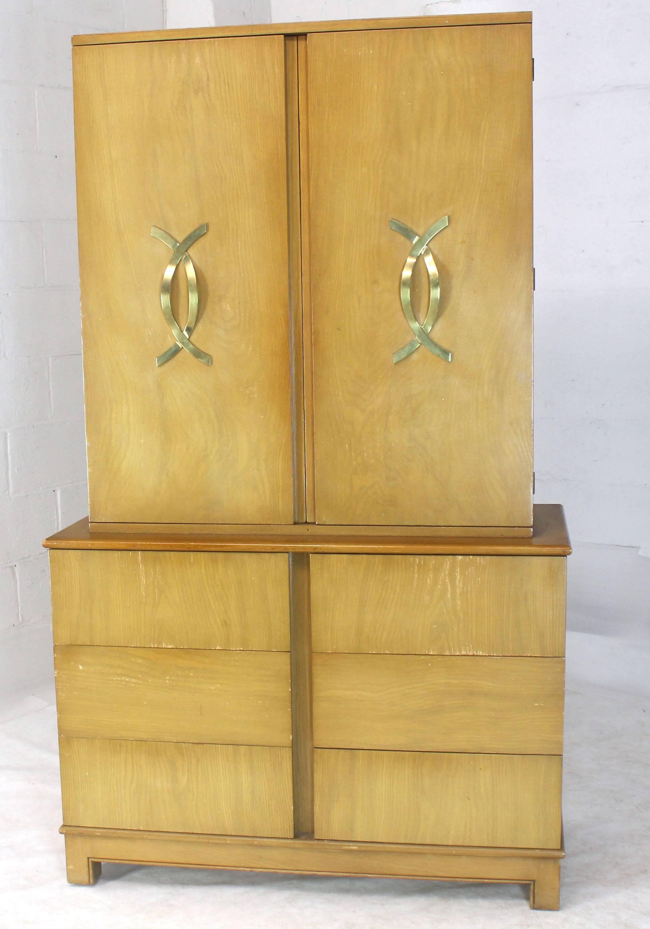 Mid century modern tall high chest with mirrored compartment and brass figural pulls. There are multiple storage drawers triptych mirror perfume shelf. Outstanding craftsmanship by Grosfeld house. 