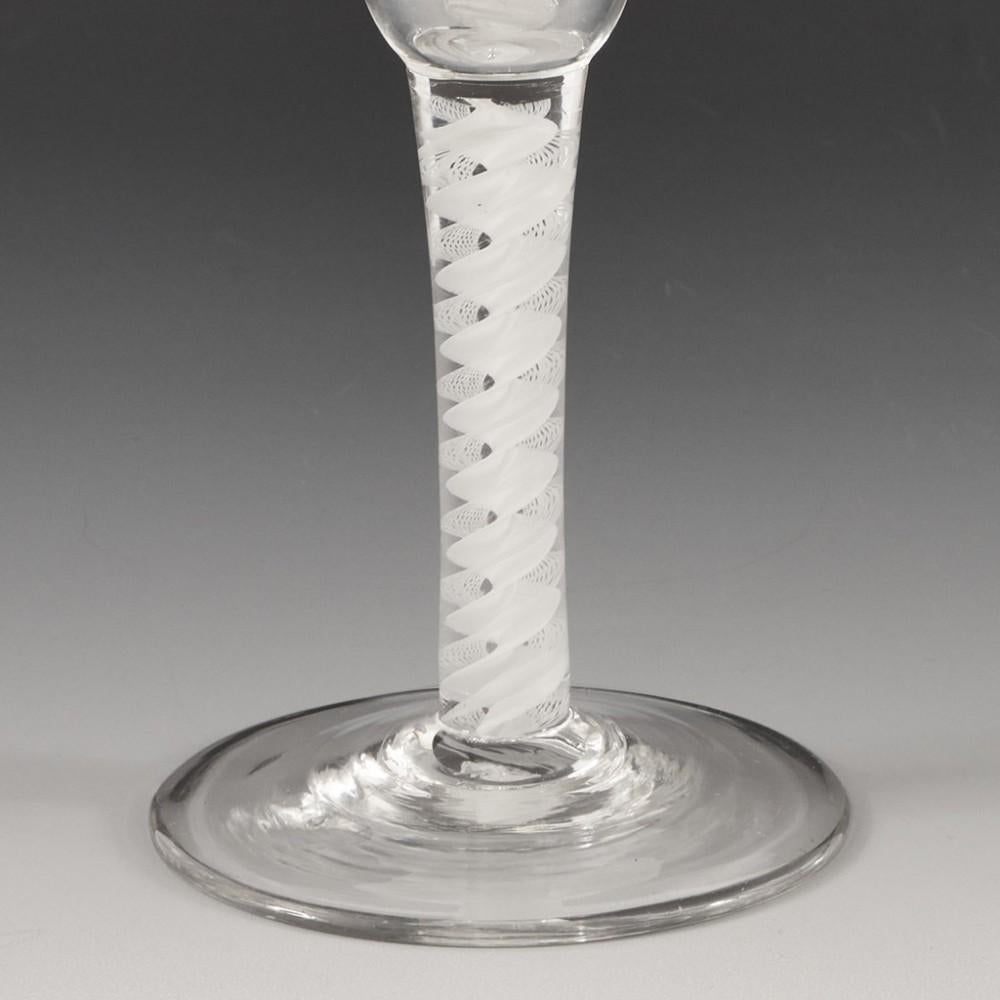 Heading : Opaque twist stem ale glass
Period : George II / George III - c1760
Origin : England
Colour : Clear
Bowl : Conical
Stem : A pair of lace corkscrews alongside a corkscrew tape
Foot : Conical
Pontil : Snapped
Glass Type : Lead
Size :  20.1cm