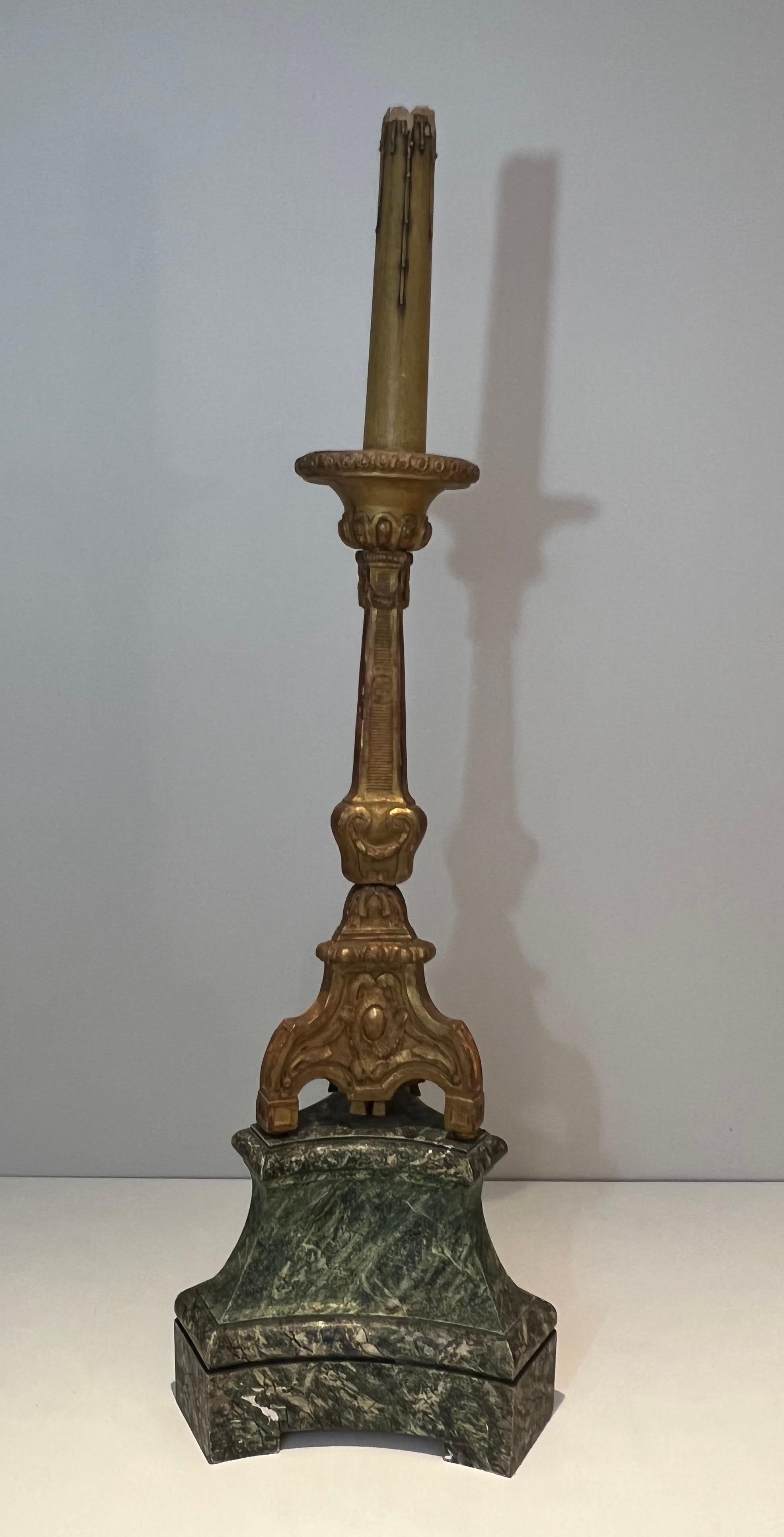 This decorative tall candelabra is made of a gilded carved wood on a patinated base. This is a French work. Circa 1900