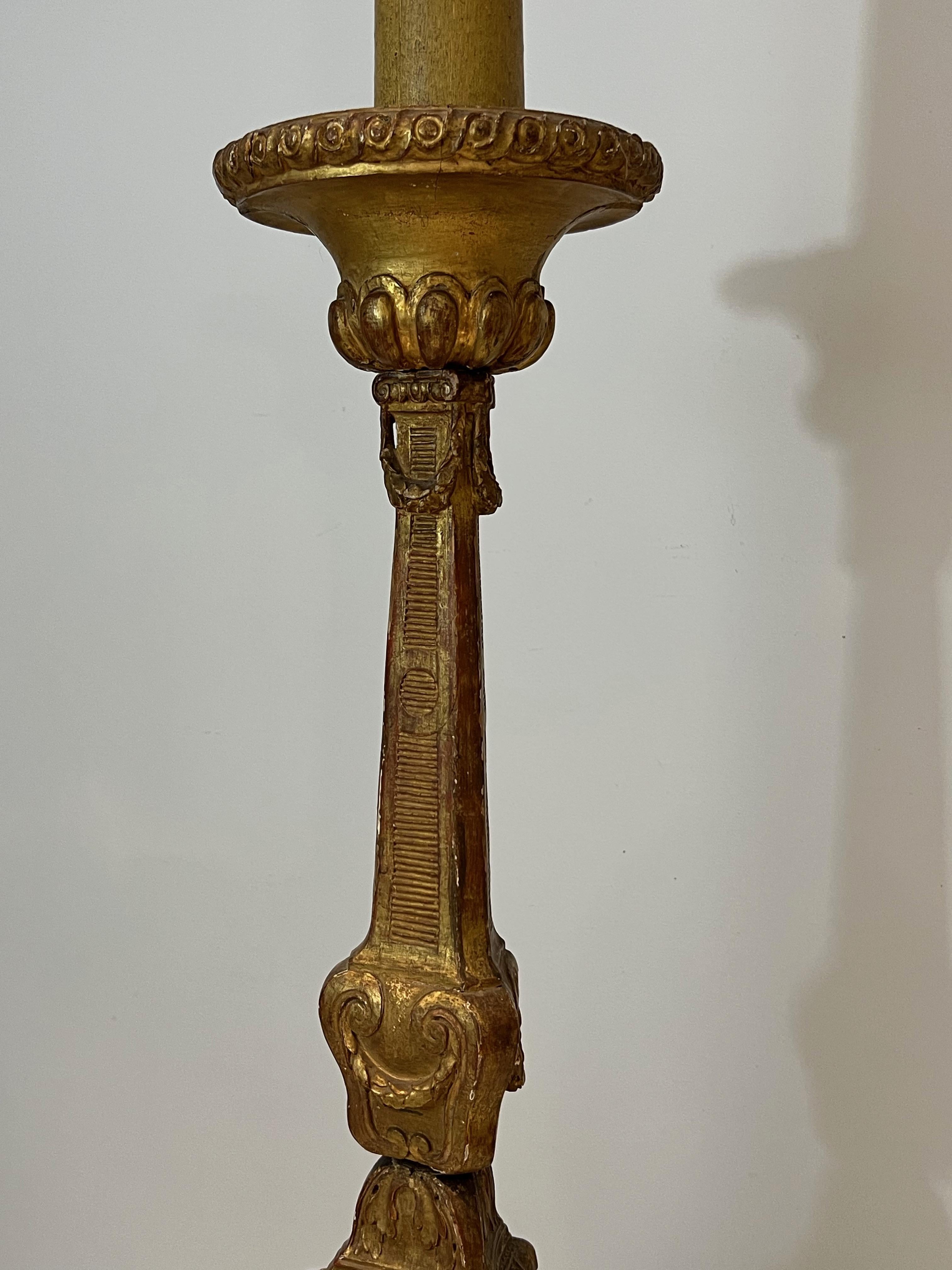 Gilt Tall Gilded Carved Wood Candelabra on a Patinated Base For Sale