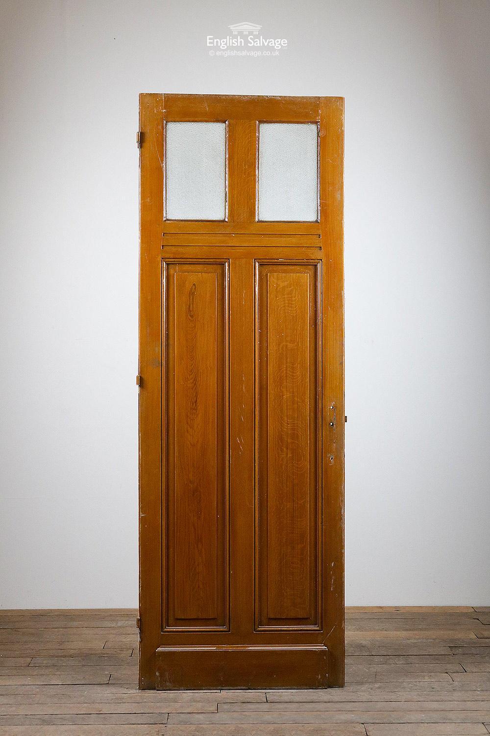 One of a set of reclaimed doors from France. Tall pine with two upper glazed panels of dimpled glass. One side has an oak effect, the other painted white. Weatherboards to both sides.