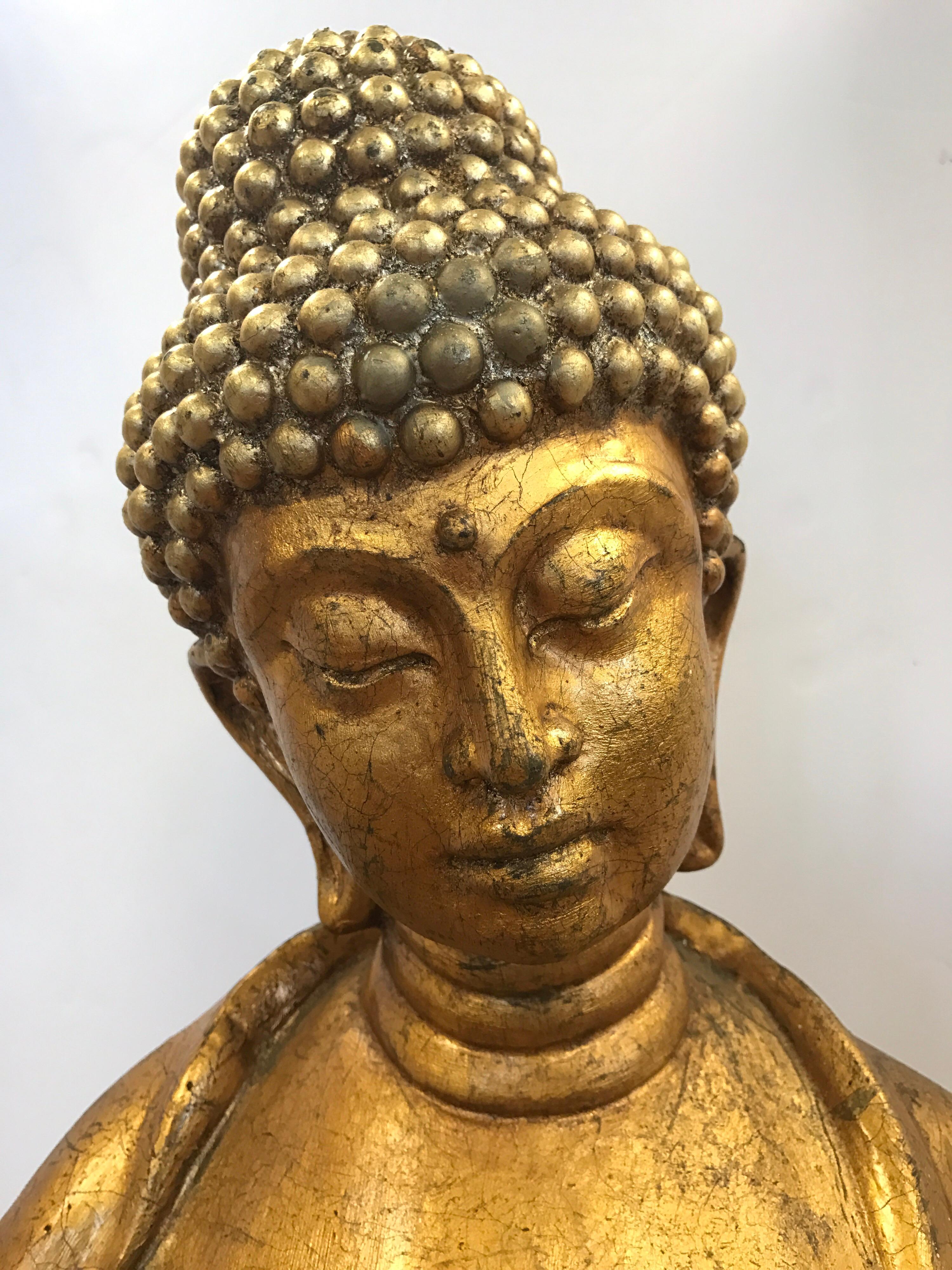 Elegant and tall standing gold gilt Buddha sculpture.