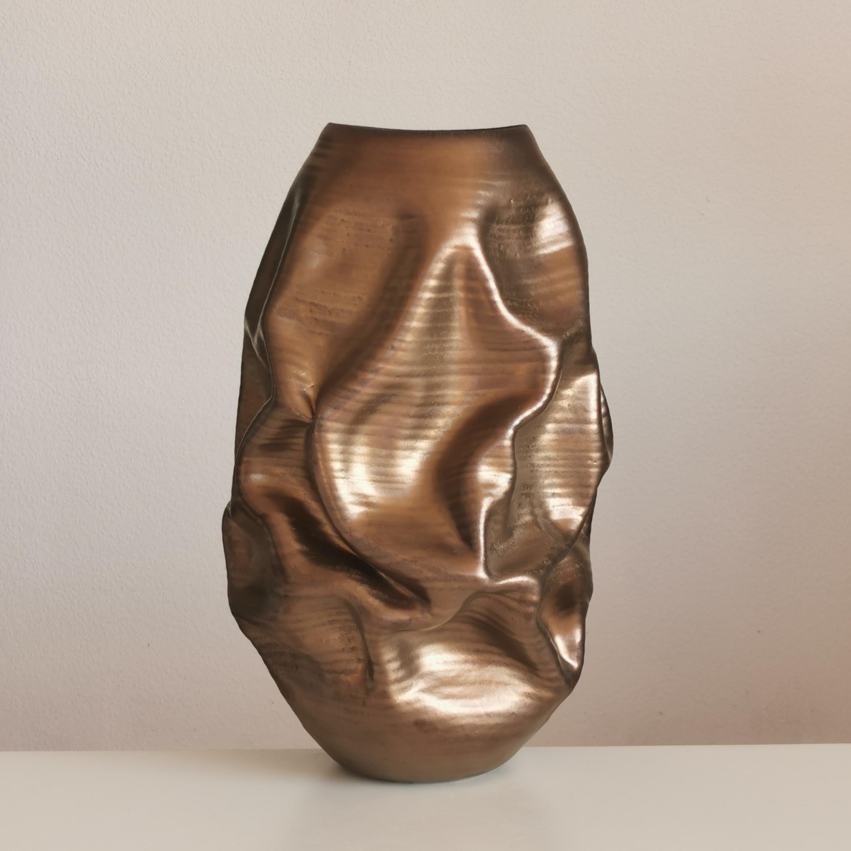 No. 97 tall golden crumpled form. Sumptuous medium sized ceramic vessel from ceramic artist Nicholas Arroyave-Portela.

White St. Thomas clay, Stoneware glazes, multi fired to cone 6 (1223 degrees)

Made in 2022

H 41 cm, W 24 cm wide, D 24