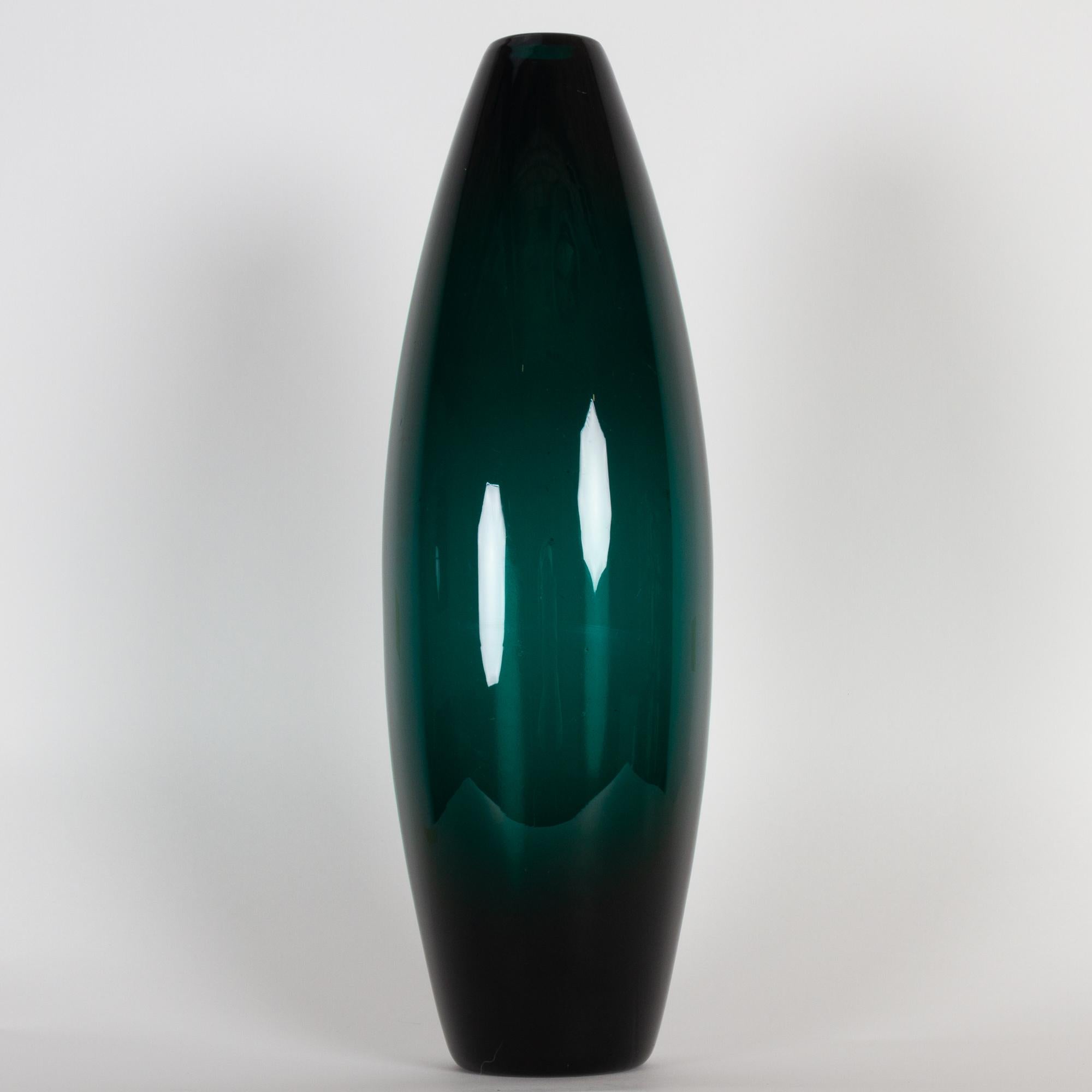 Tall Greenland torpedo vase by Per Lütken for Holmegaard, 1960s.
This tall torpedo shaped mouth blown vase from Holmegaard glassworks Greenland-series is designed by artist Per Lütken in 1960. All the items in the Greenland series has this