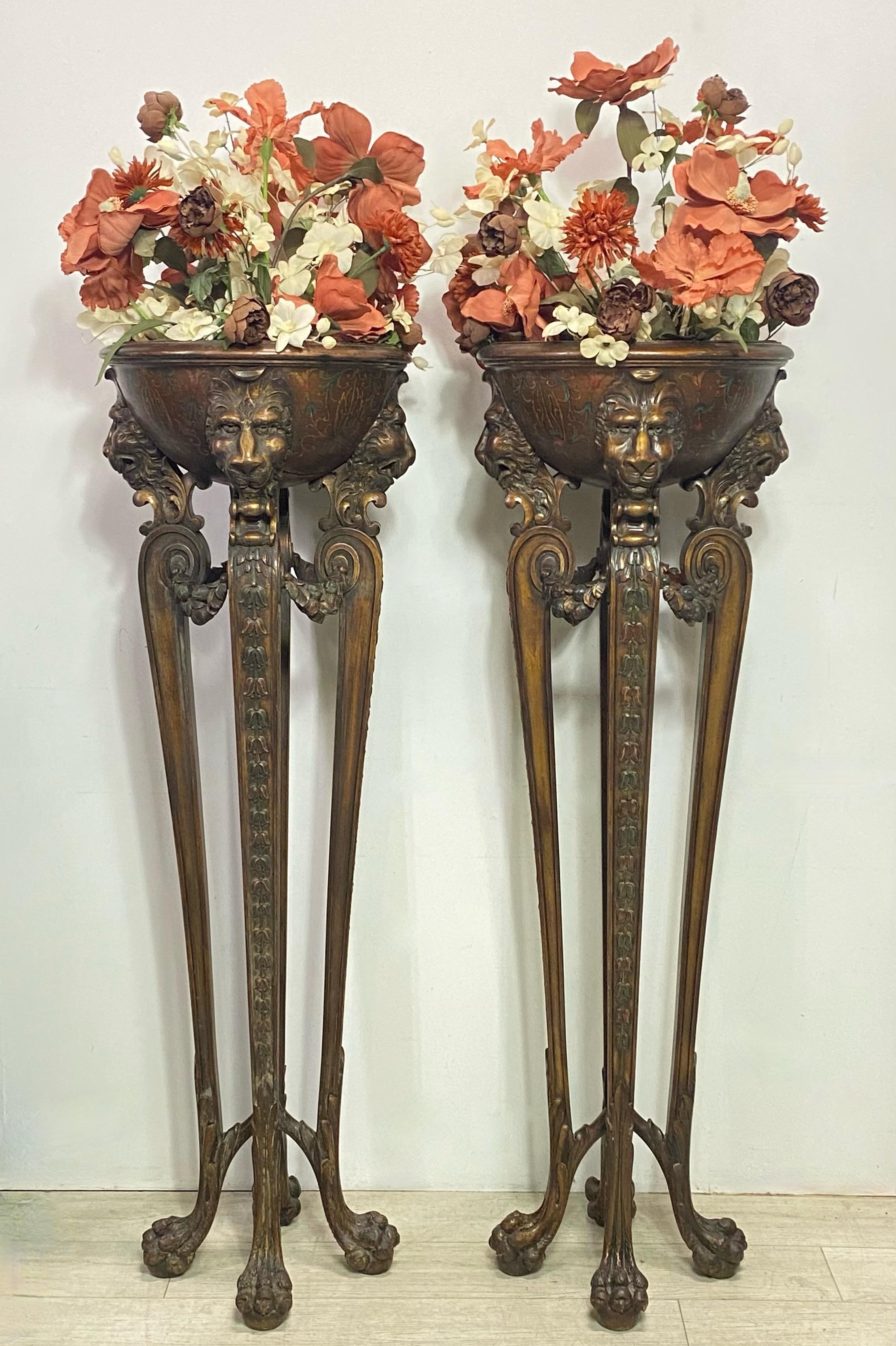A pair of tall elaborately carved and painted walnut plant stands with wonderfully detailed lion faces and hairy paw feet, having their original hand hammered copper liner inserts.
Most likely European, circa 1920.