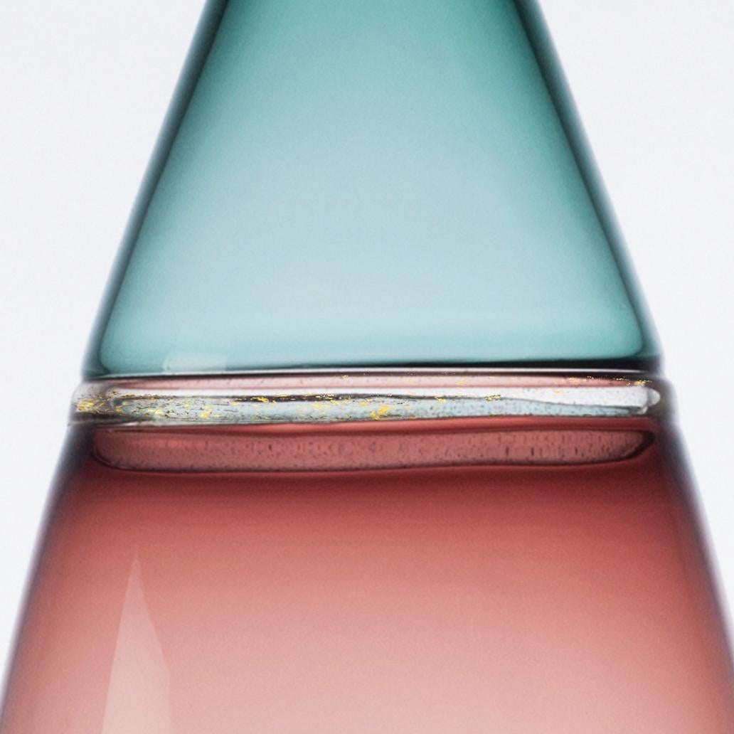 Tall and voluminous, this hand blown glass statement vase features rosy 