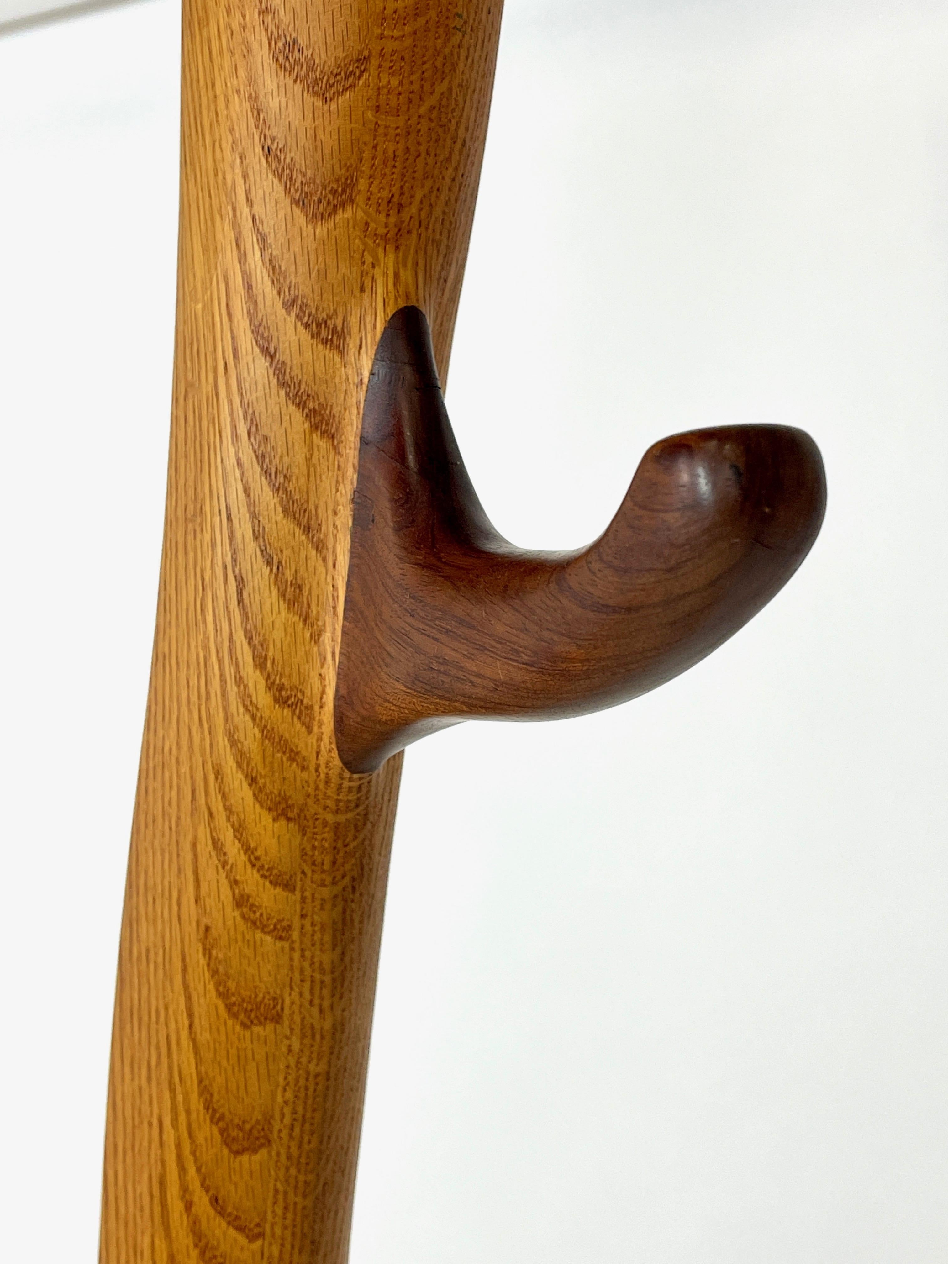 Large and sculptural handcrafted coat hanger sculpture constructed of solid oak with rosewood detail. This piece is incredibly heavy and absolutely stunning in person. Form meets function at it's best. Maker unknown.