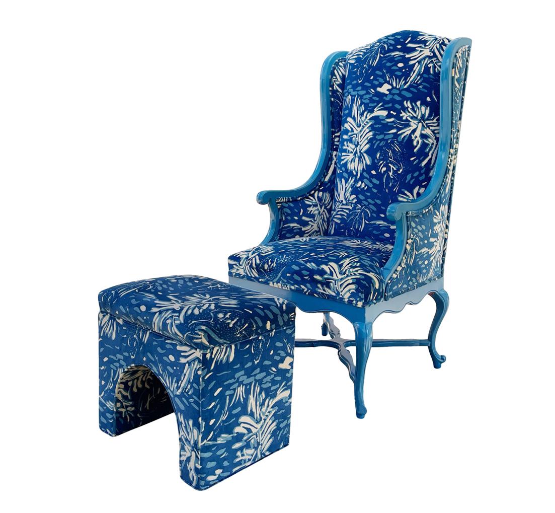 A 1970's decorator classic. A blue framed classical french armchair. with a blue print velvet, and arched footstool.