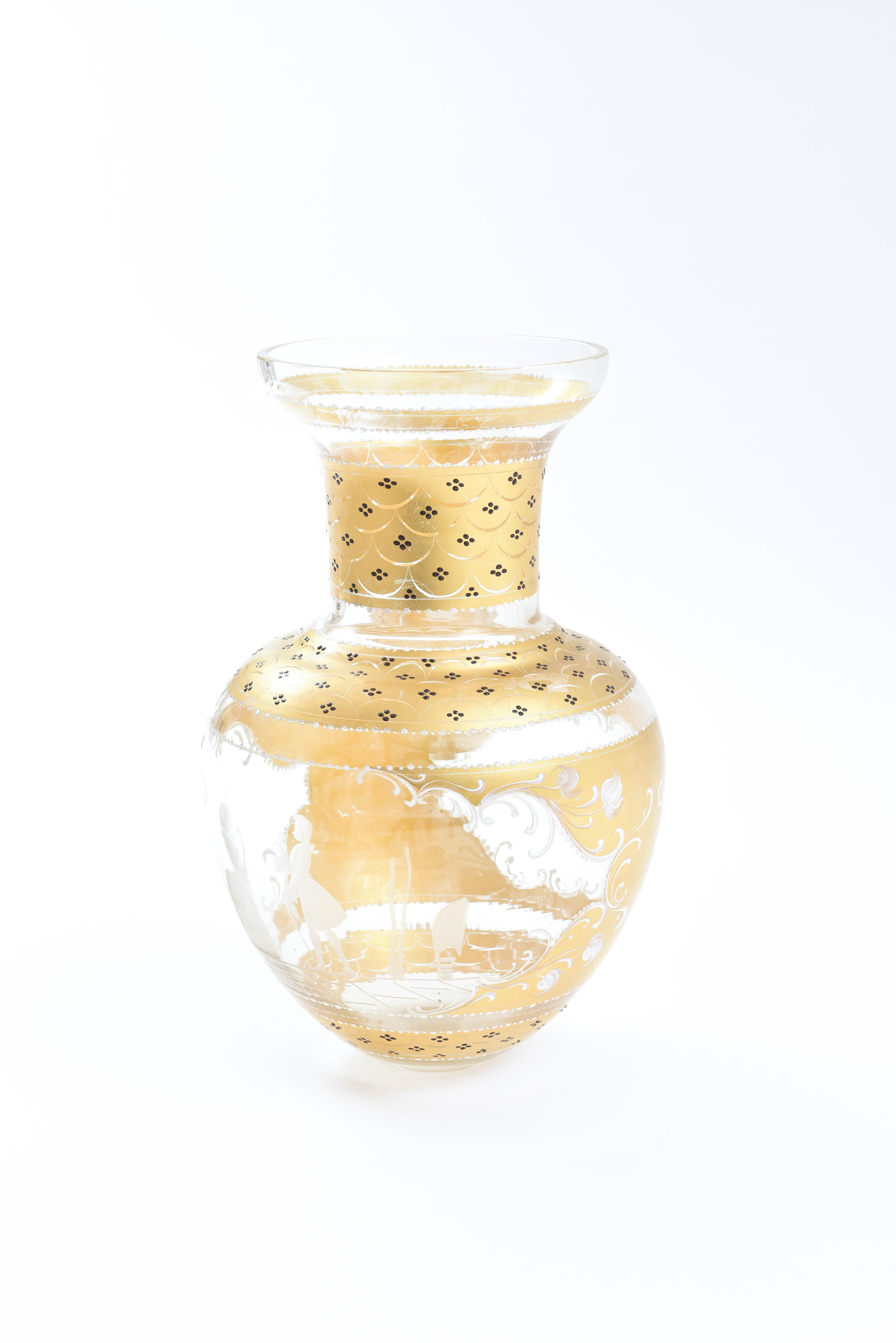 This vase also features beautiful 24-karat gold decoration throughout and two different hand etched scenes. One is a traditional 18th century courting couple and the other panel has a delightful village vista. Please note the extra tall size and
