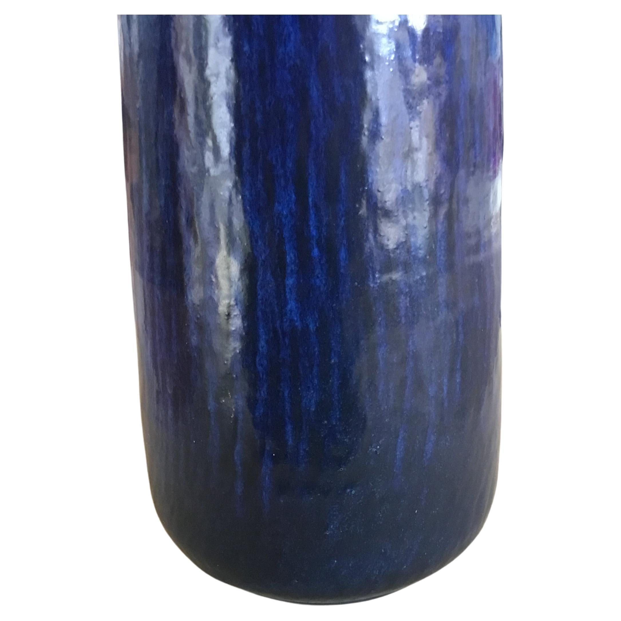 This very tall and slender vase was designed by Gunnar Nylund for Nymølle and produced in Denmark, circa 1960´s. It has a vivid dark navy blue glaze over a radiating pattern. Measure: 17.7” Tall.

The vase is a first edition and in very good vintage