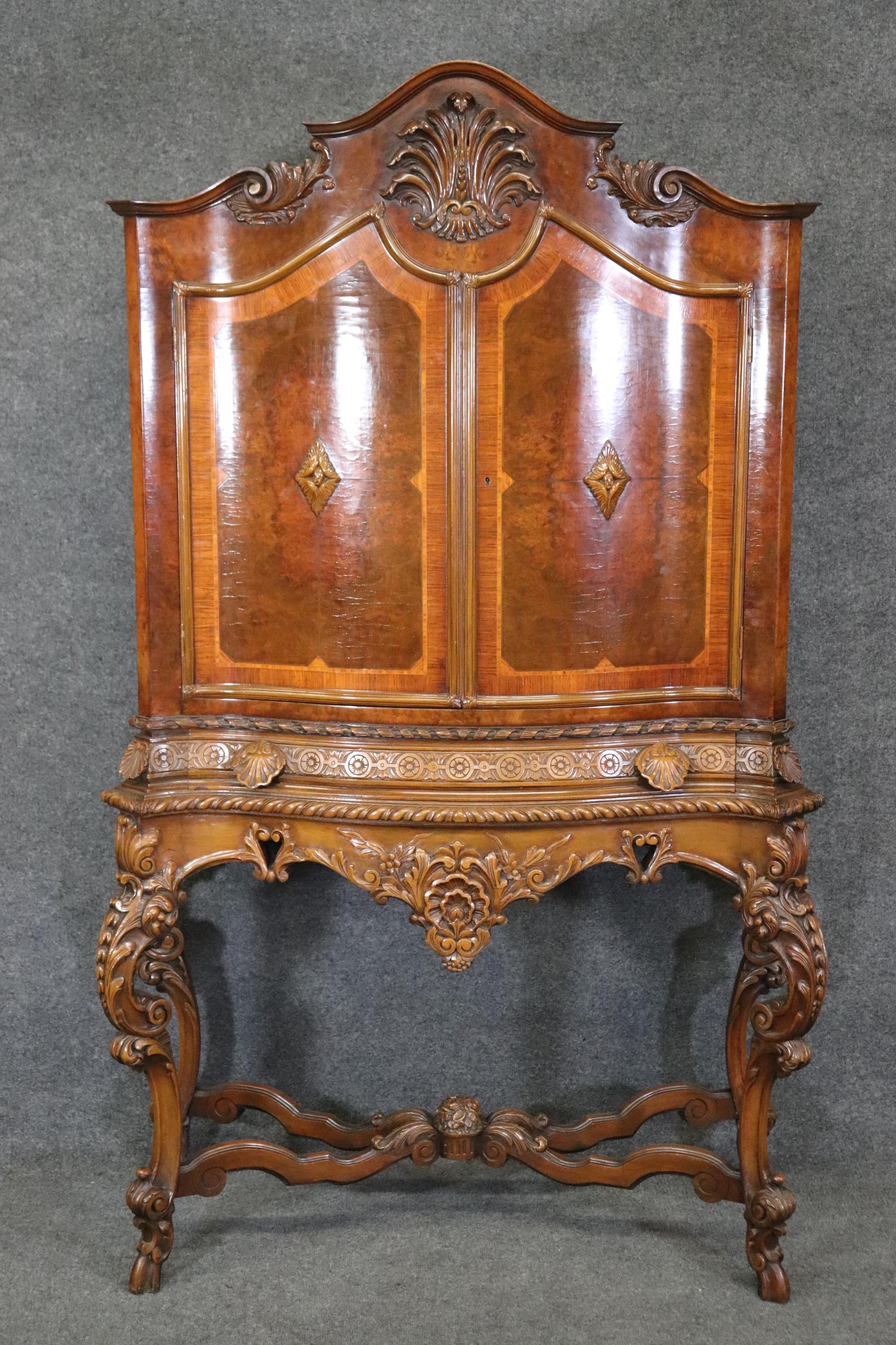 This is a beautifully designed cabinet in the Louis XV cabinet in solid and inlaid walnut. The cabinet has its orginal finish and will show craquelure in the finish of the doors and this is to be expected. The cabinet measures 75.25 tall x 50 wide x
