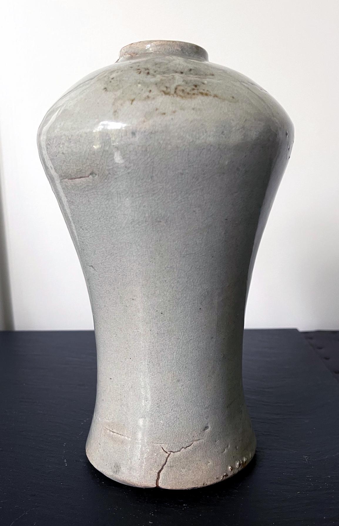 A Korean ceramic storage jar circa 18th century of Joseon Dynasty. The jar is of a classic Maebyong form (known in Chinese as Plum Vase or Meiping). The vase features raised shoulder above a tall and slender body and a small mouth opening. This form