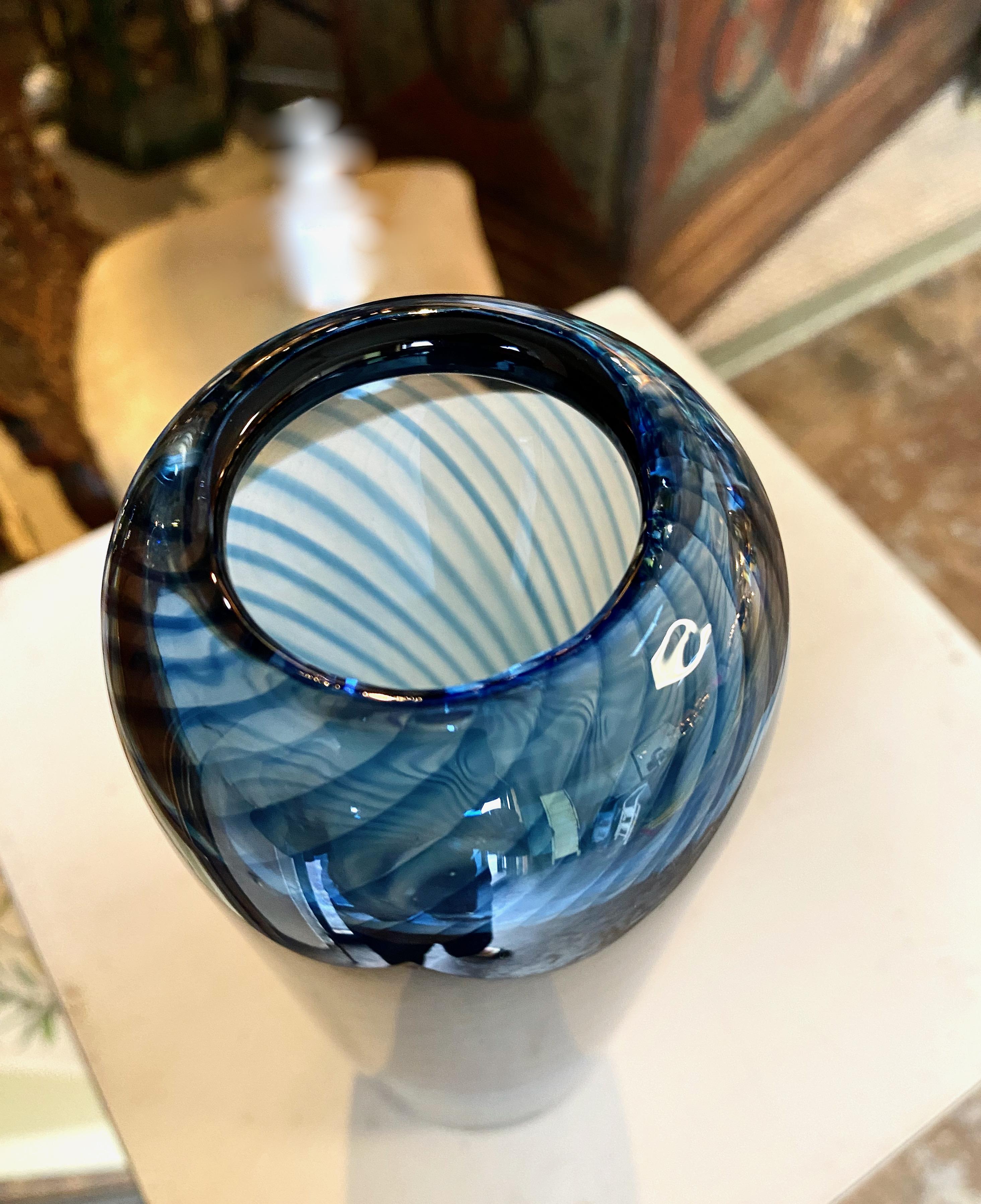 This is a stunning example of the Swedish glass creator, Kosta Boda. the vase measures a full 11 inches in height and is created in a stunning intense blue with a darker blue filigrana internal twist. The vase is attributed to the design of Vicki