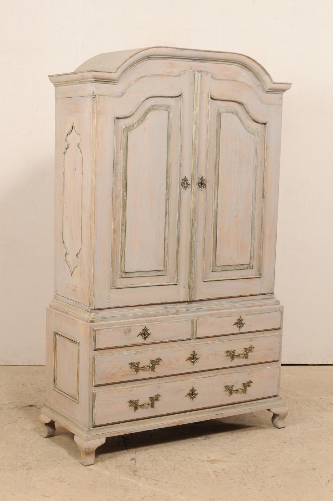 A beautiful Swedish late 18th century period Rococo painted wood cabinet. This spectacular antique cabinet from Sweden features and upper cabinet of two grand doors that open to reveal a spacious interior with three shelves and a full width drawer,